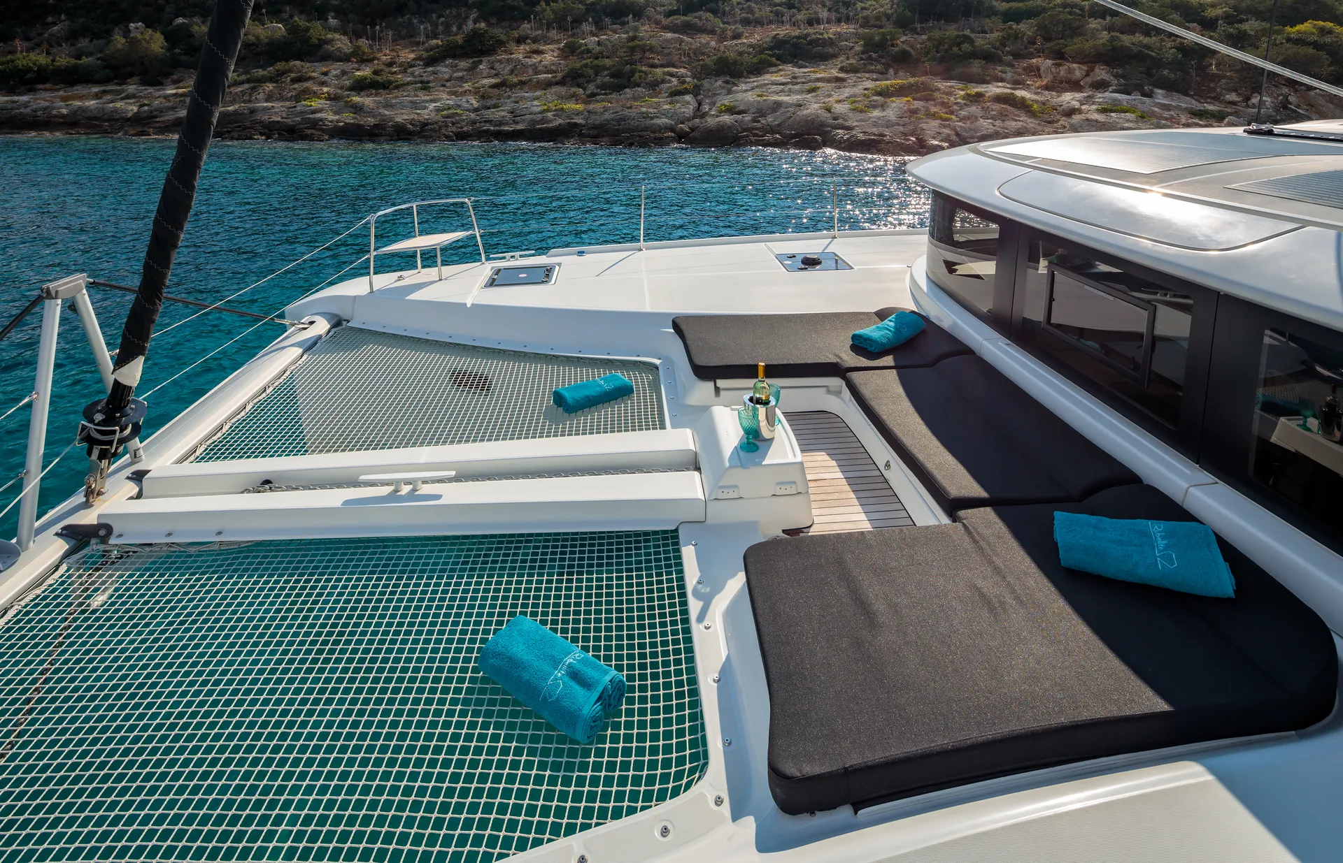 White Rock 36 speedboat with captain at helm cruising calm blue waters near Paros coastline with hills in background.