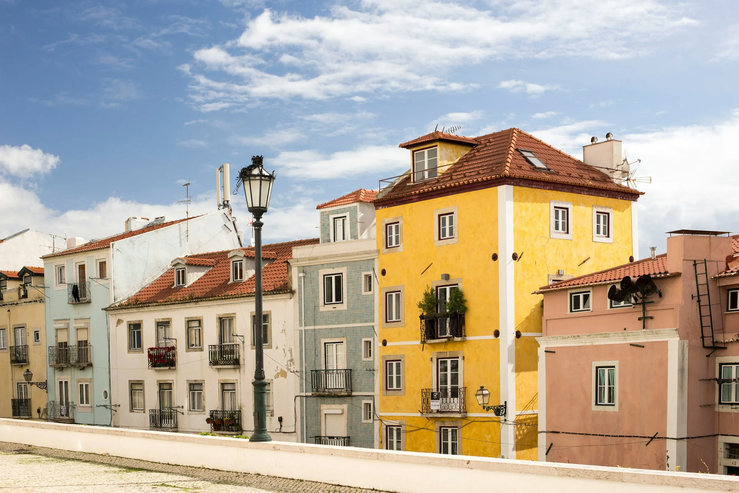 Pastel houses on a sunny Lisbon street