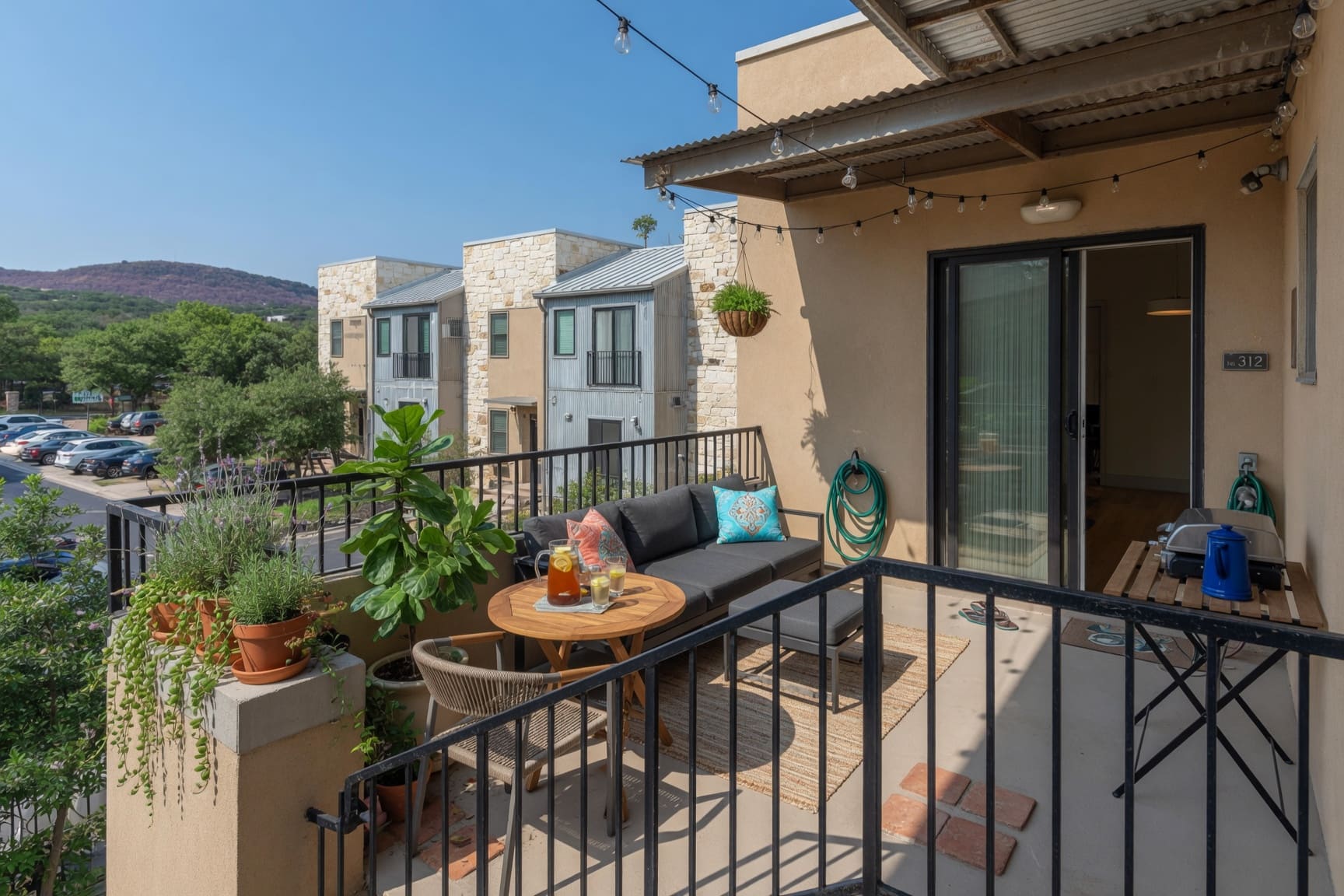 Private balcony with outdoor seating and neighborhood views