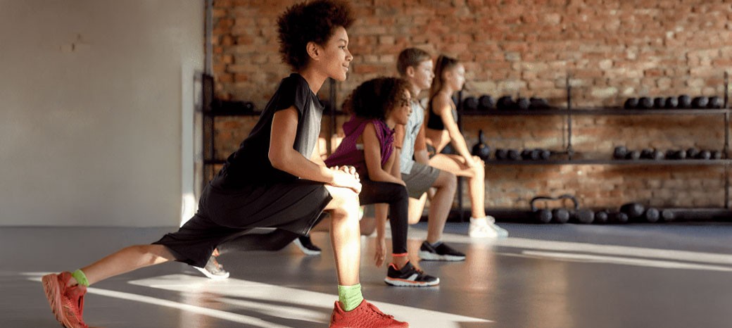 Students participating in structured physical education activities focused on fitness, coordination and teamwork