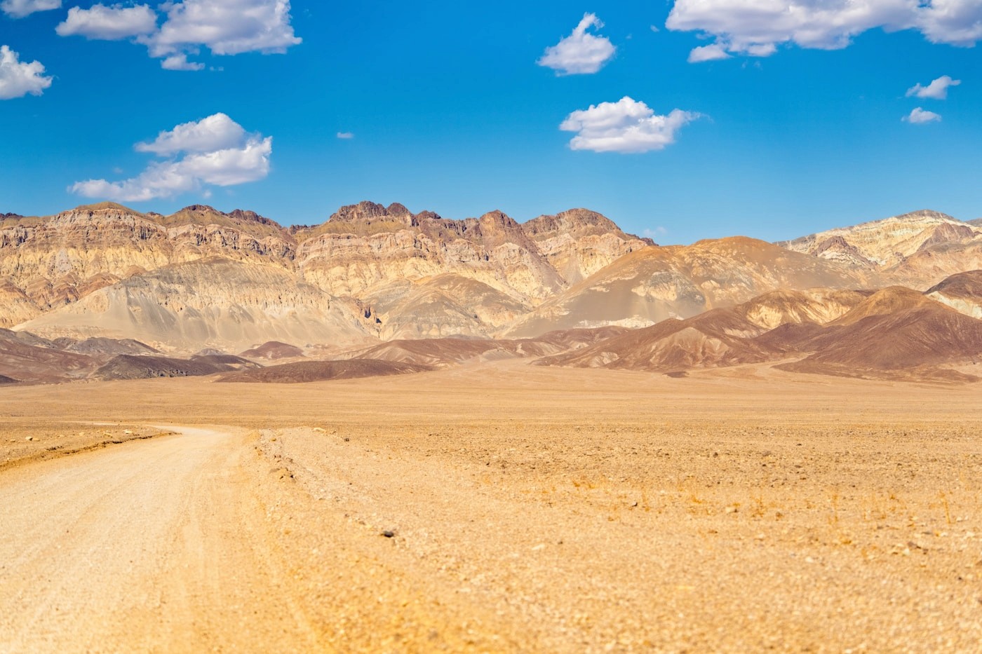 A convoy of 4x4 vehicles on a Namibian gravel road