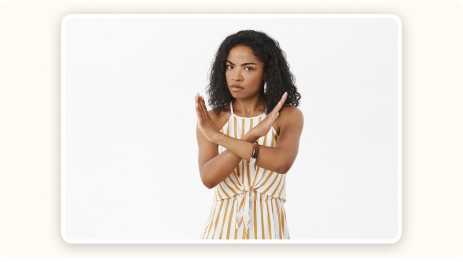 Woman crossing arms in refusal gesture with serious expression