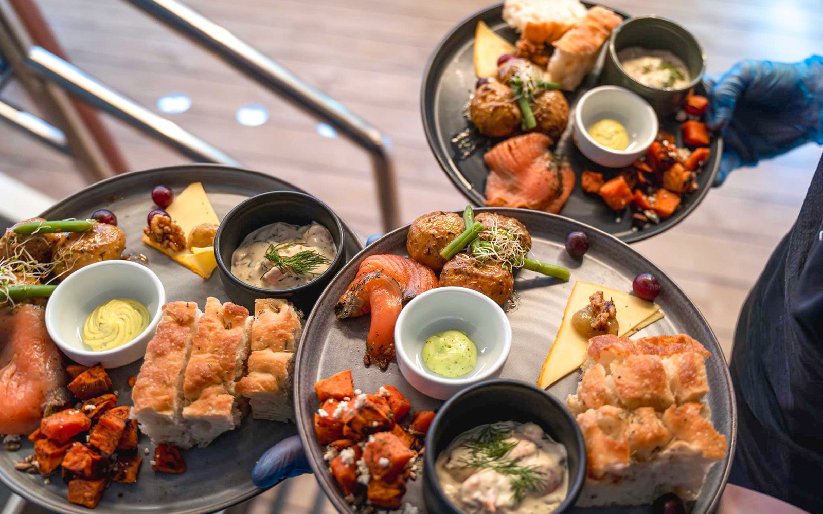 Gourmet dishes served on a dinner cruise, featuring salmon, potatoes, and bread.