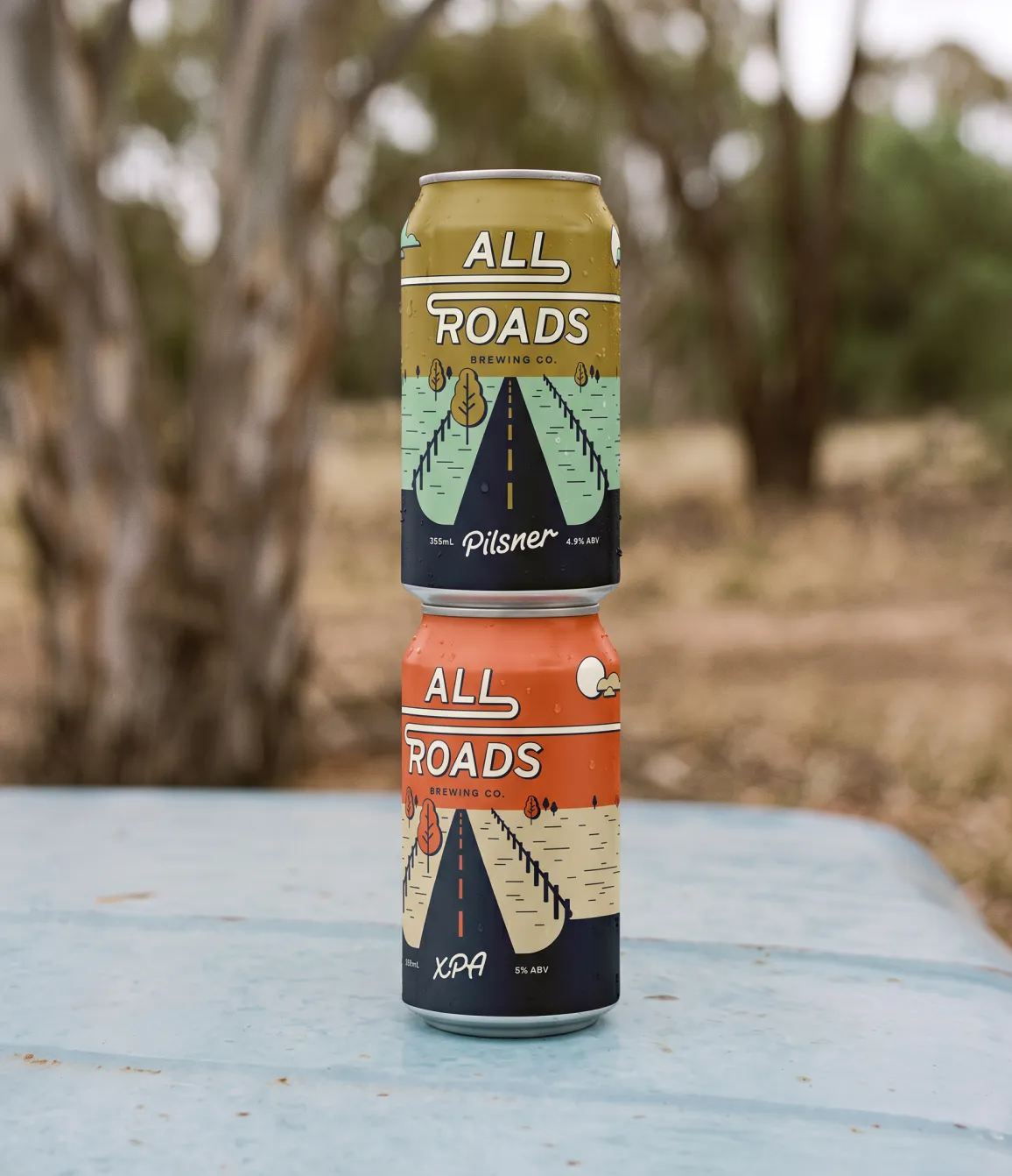 All Roads Brewing Co. Pilsner and XPA cans stacked outdoors
