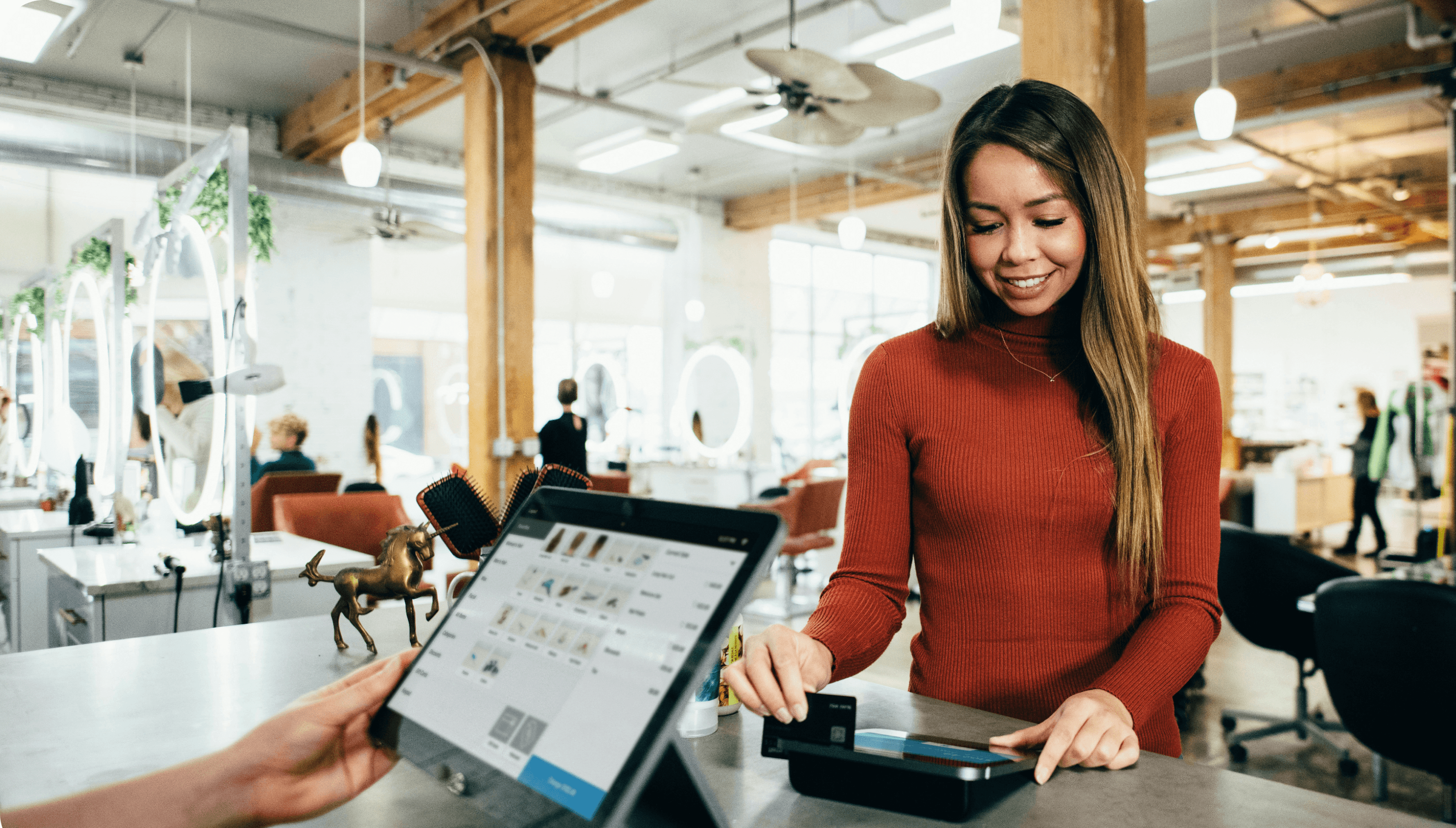 Woman completing a payment at a POS terminal