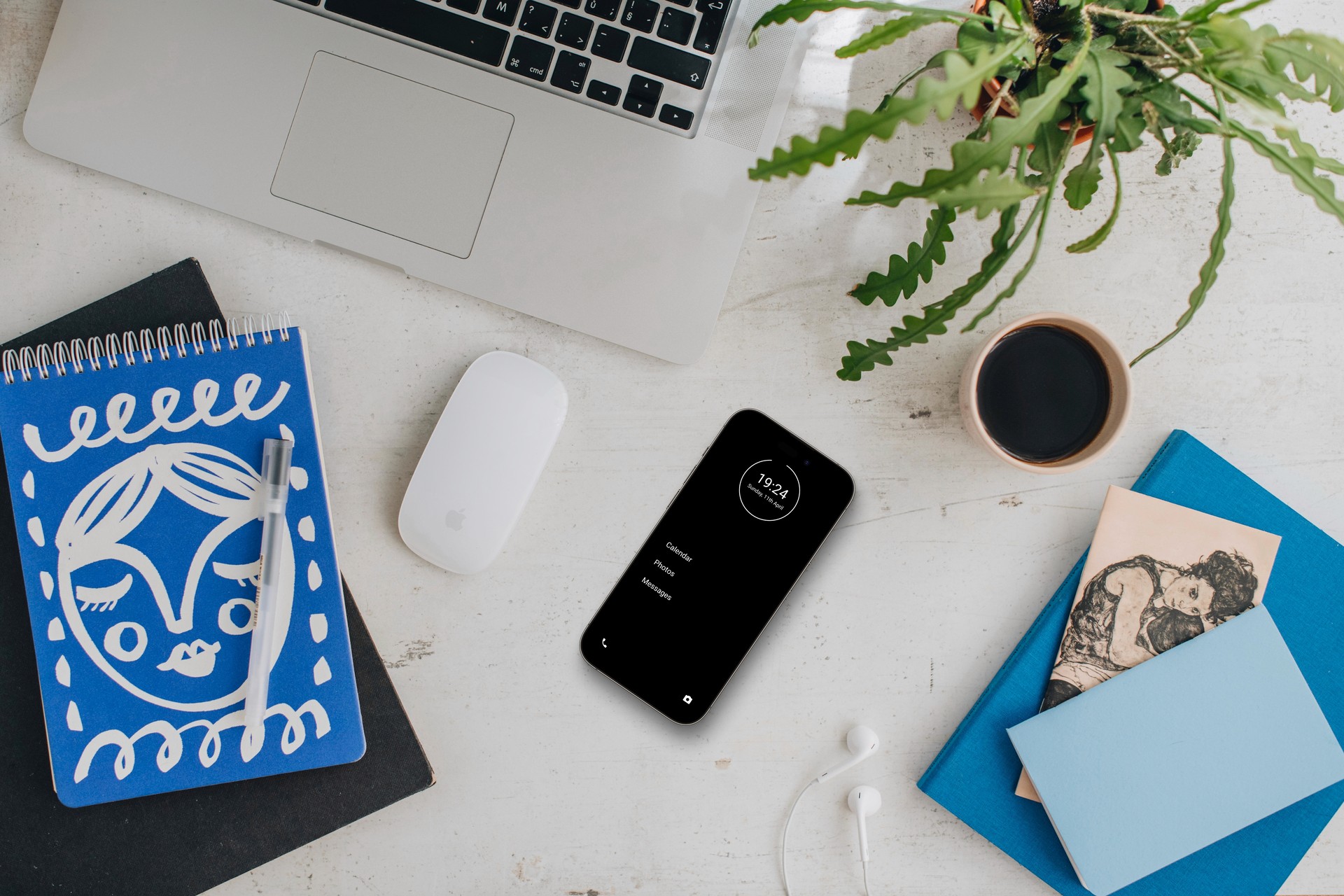 Smartphone with minimalist phone interface on a work desk, supporting a distraction-free digital setup.