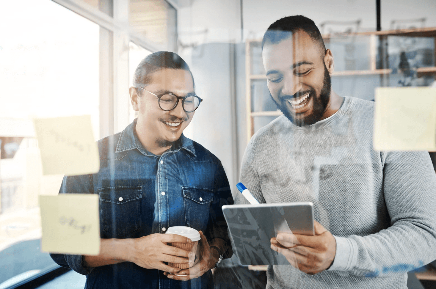Colleagues reviewing results on a tablet, monitoring Amazon PPC performance after removing overlap and improving efficiency.
