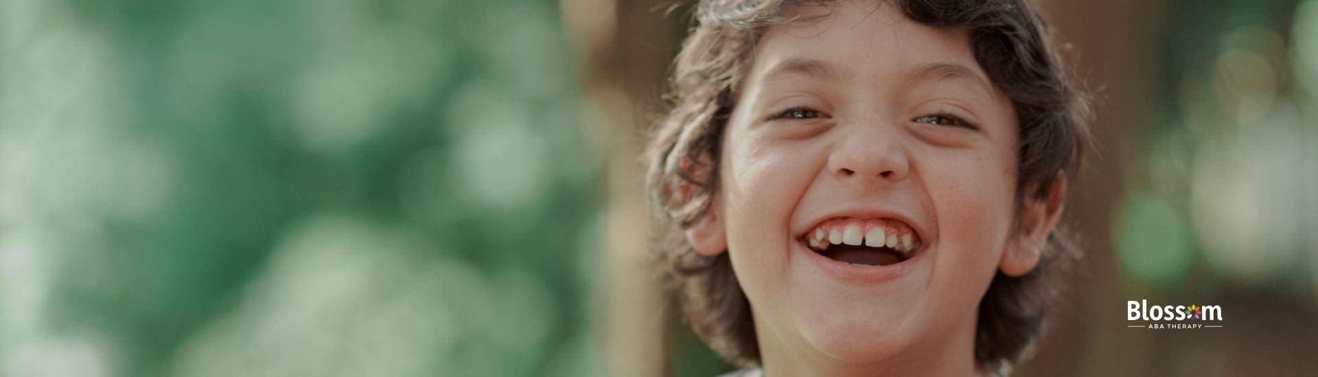 A little boy smiling.