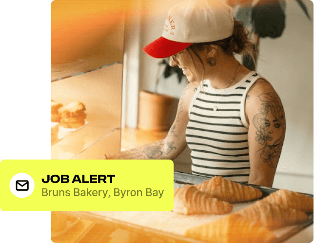 Job alert notification for Beach Hotel, Byron Bay, over a photo of a worker at a bakery