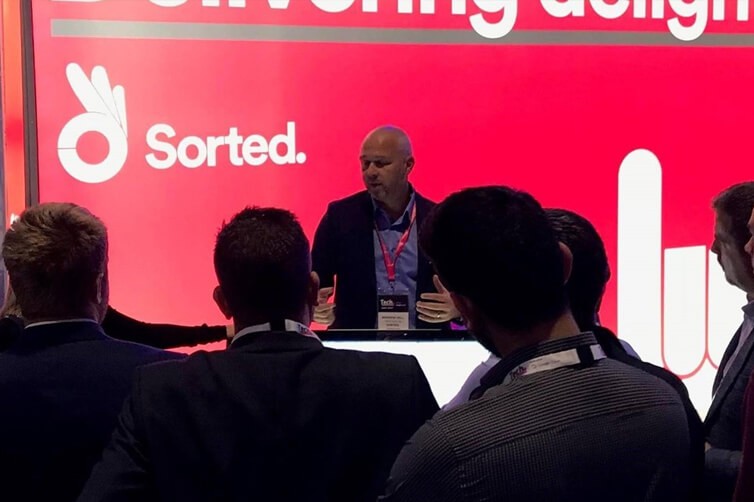 Speaker presenting at Sorted event stand to audience