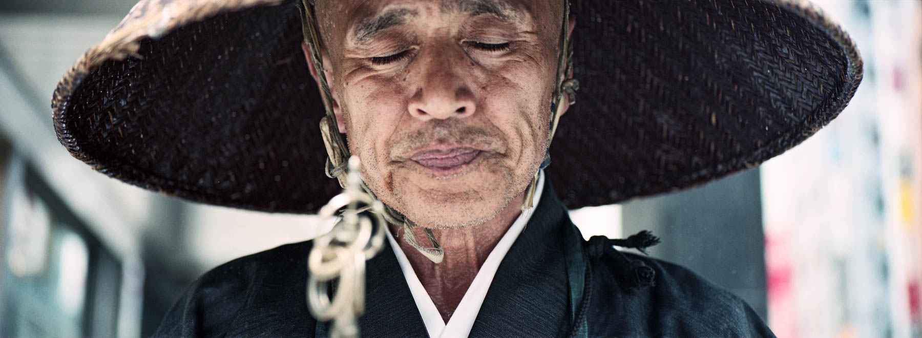 The Monk photographed on Kodak Portra with the Hasselblad XPan in Shibuya, Tokyo, Japan, showing a peaceful and calm moment in a bustling city.