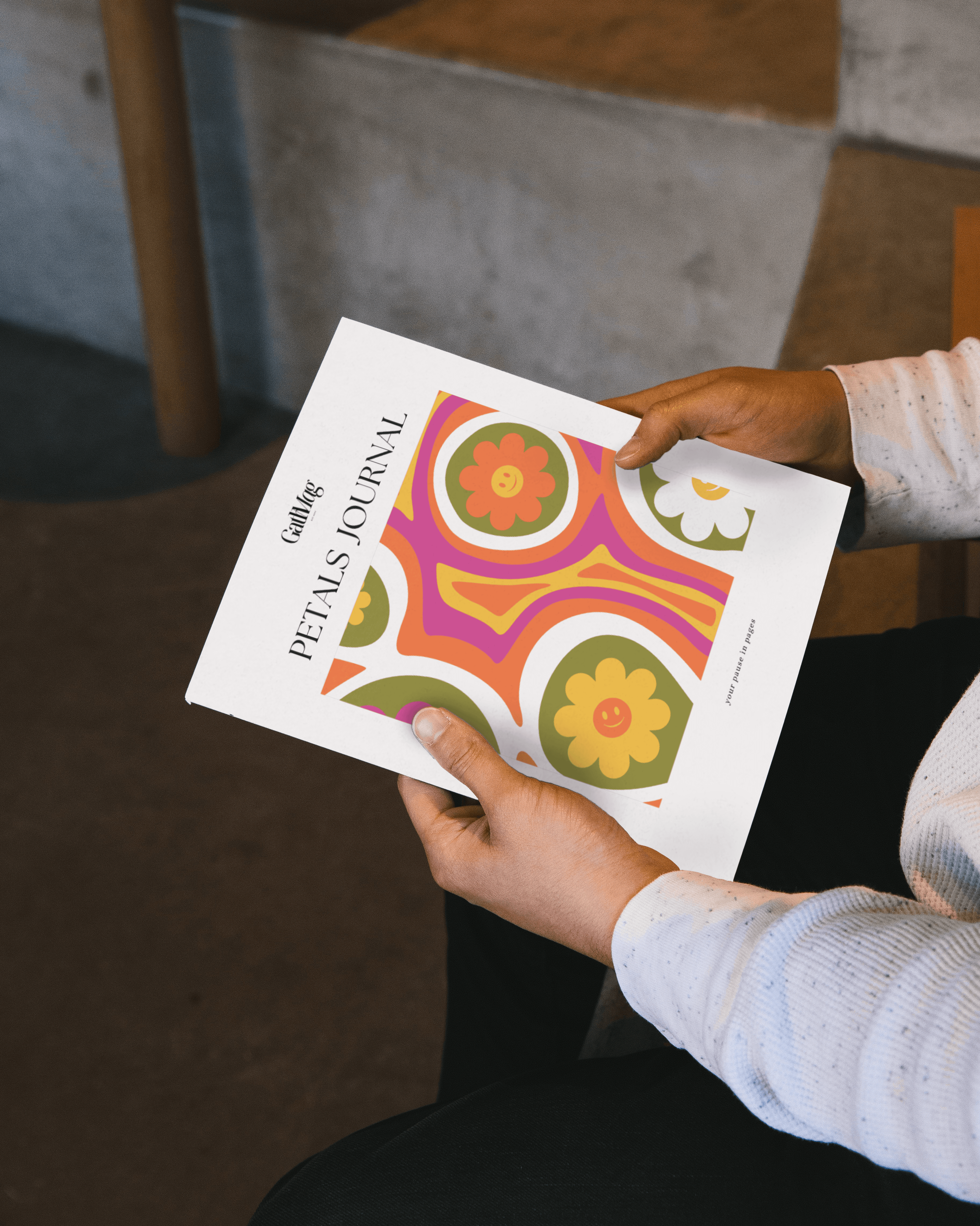 Person wearing a beige apron whisking green matcha tea in a ceramic bowl on a kitchen counter.