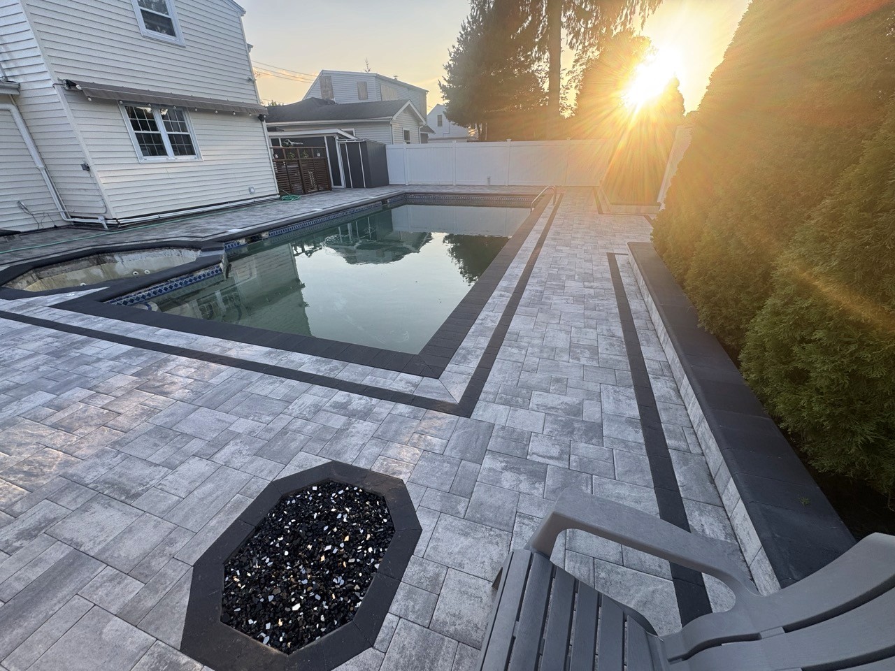 Custom outdoor kitchen with stone veneer and paver patio by CMC Masonry on Long Island