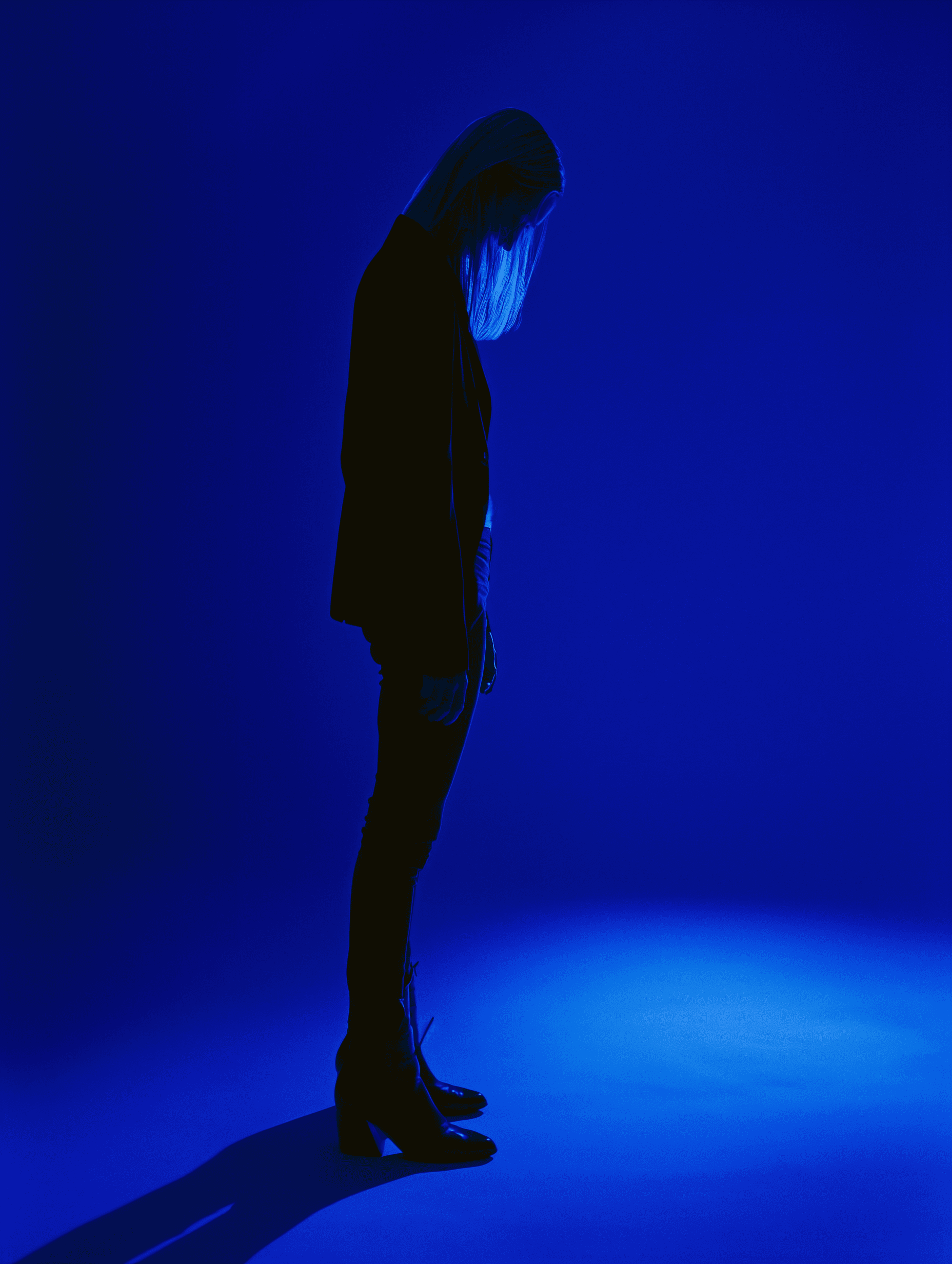 aesthetic blue photo of a blonde woman in black clothes