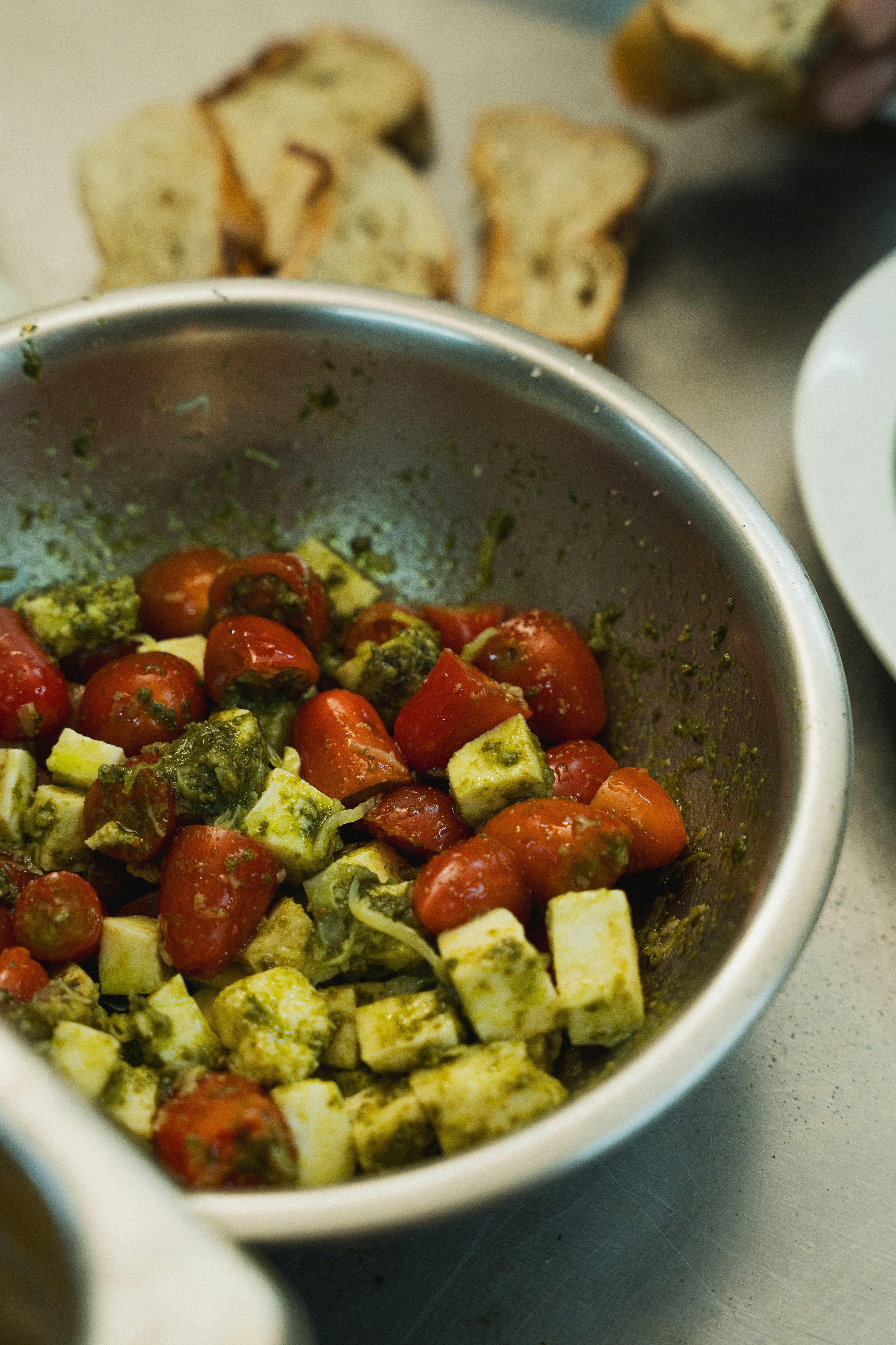 Fresh caprese salad is being prepared.