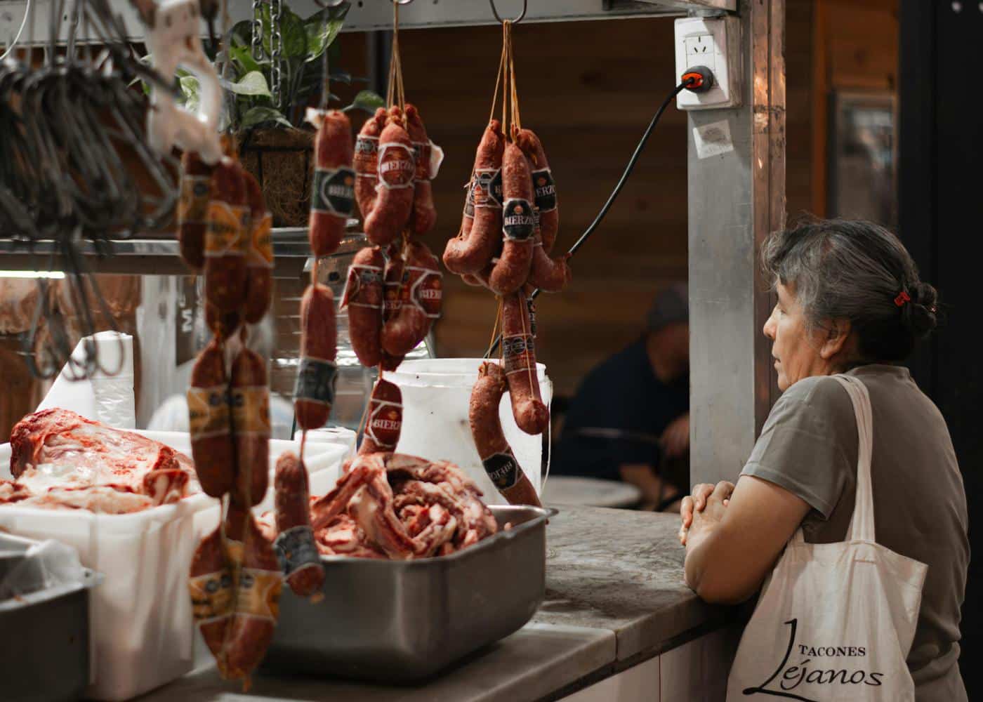 Woman standing at butcher's counter