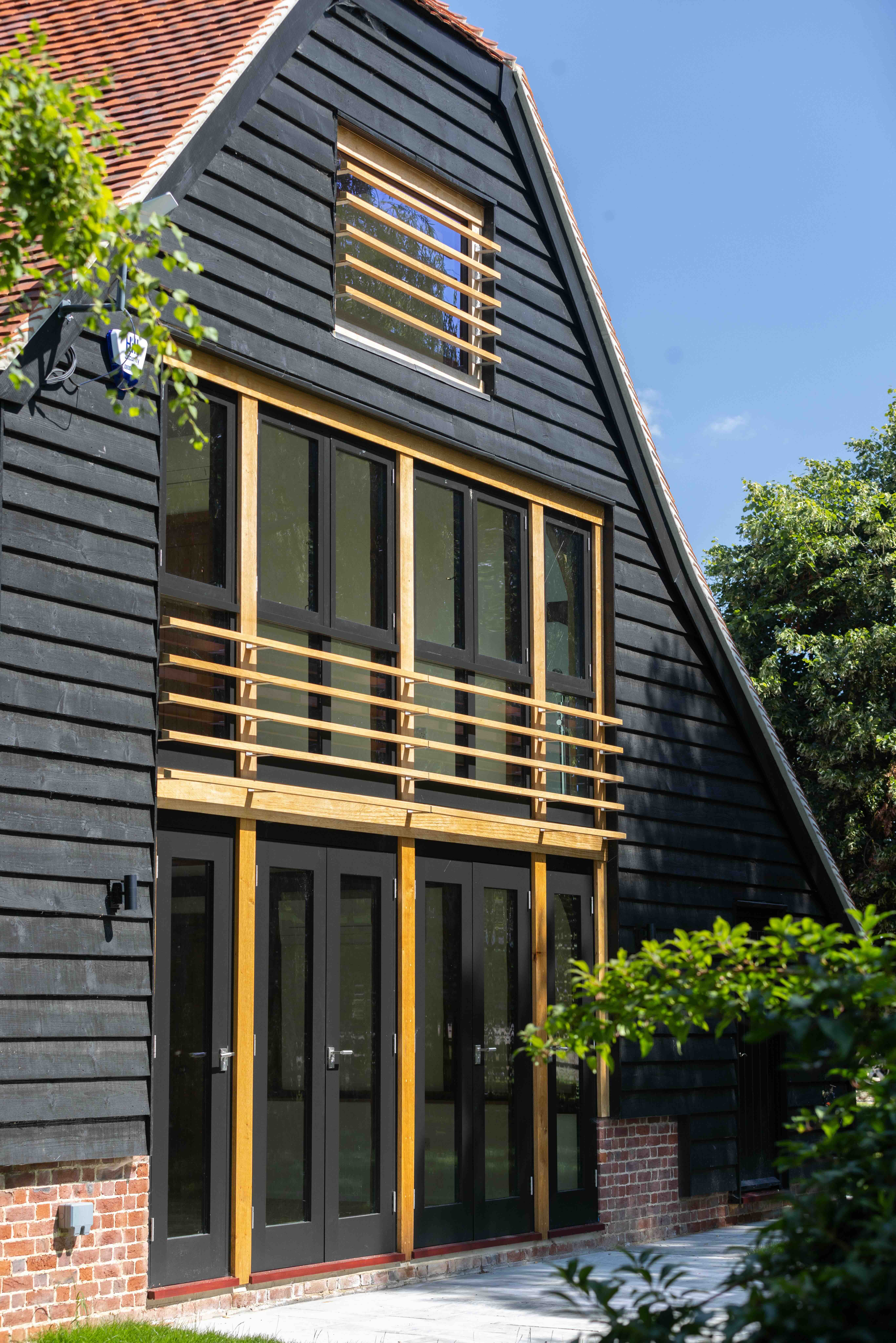     External view of oak-framed barn reconstruction, re-establishing the character of a historic agricultural building in Oxfordshire