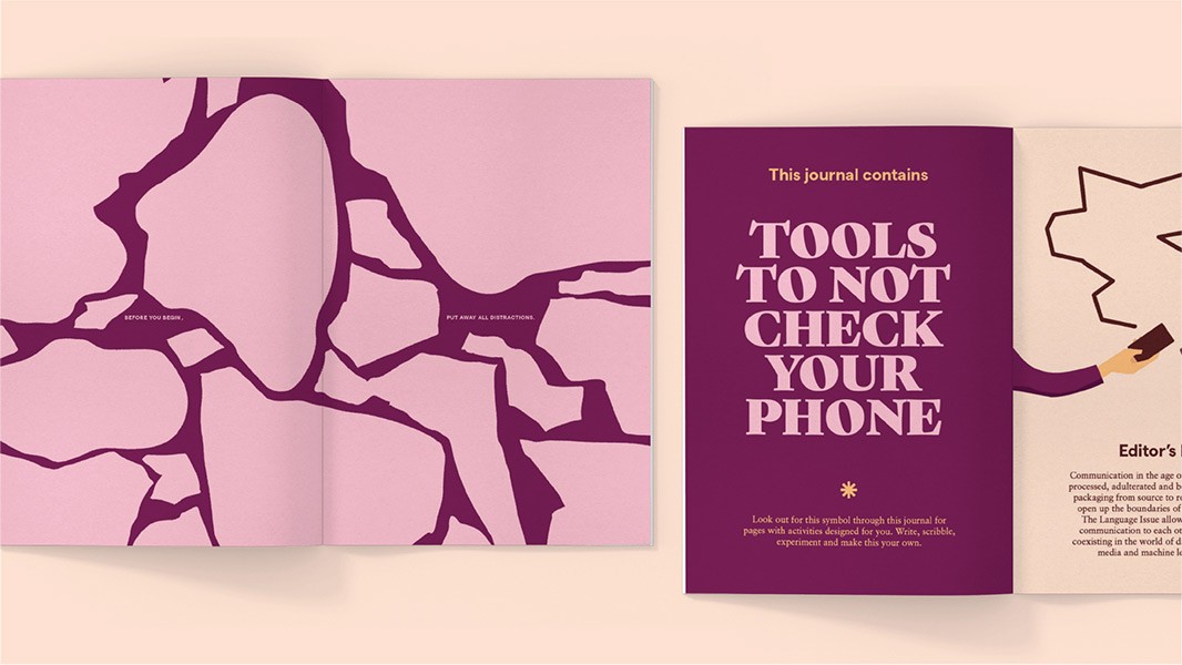 The image shows an open journal with a purple cover and a pink background. The cover features a design of dark purple, irregular shapes resembling cracks or branches. The title "TOOLS TO NOT CHECK YOUR PHONE" is prominently displayed in white text on the cover. A small asterisk symbol is visible near the bottom right corner of the cover. The inside of the journal shows a cream-colored page with black text, including the phrase "Editor's Communication in the age of...". A hand is depicted holding a book near the top right corner of the page. The journal is presented against a light beige background.