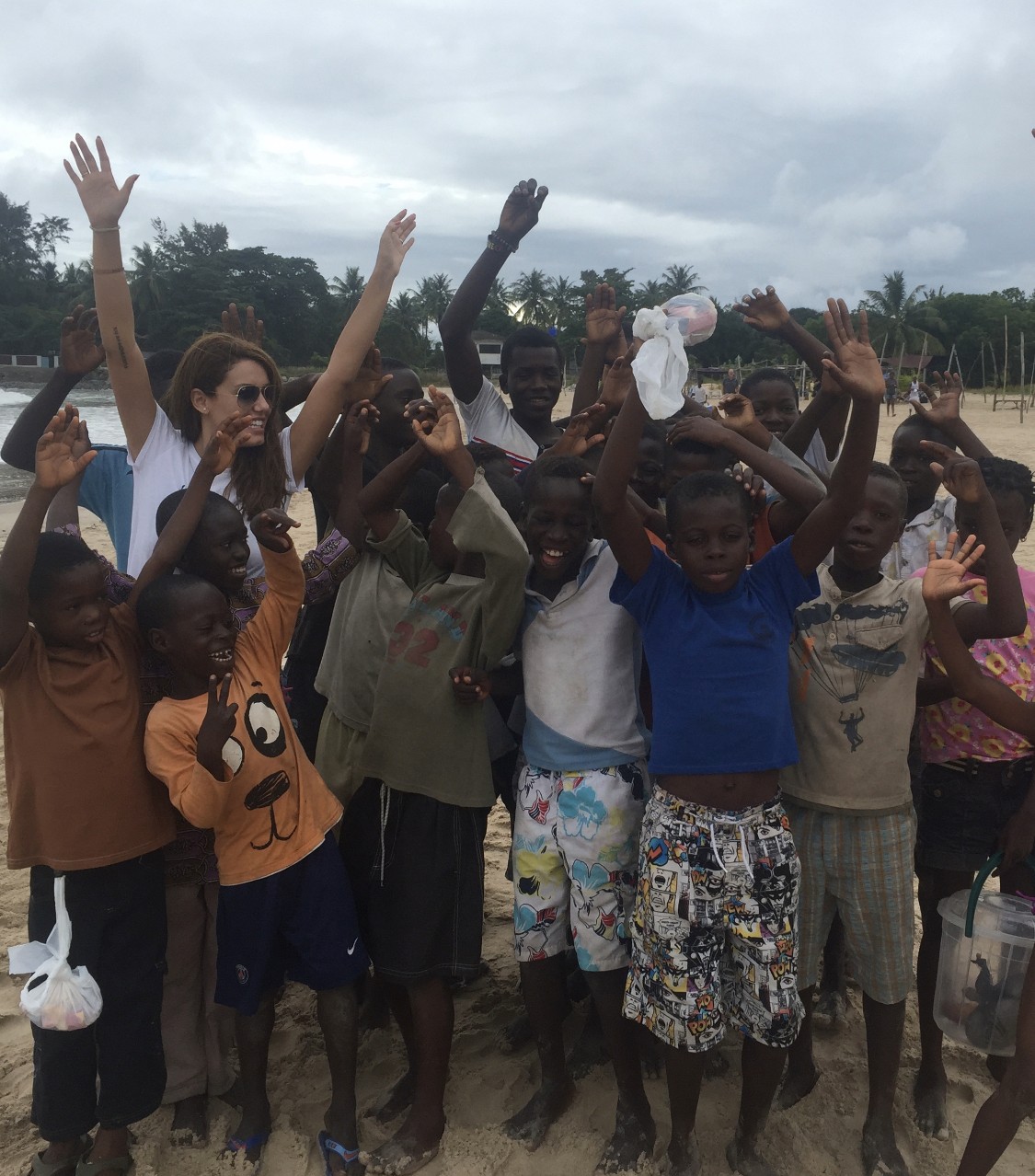 a woman holding a red flower