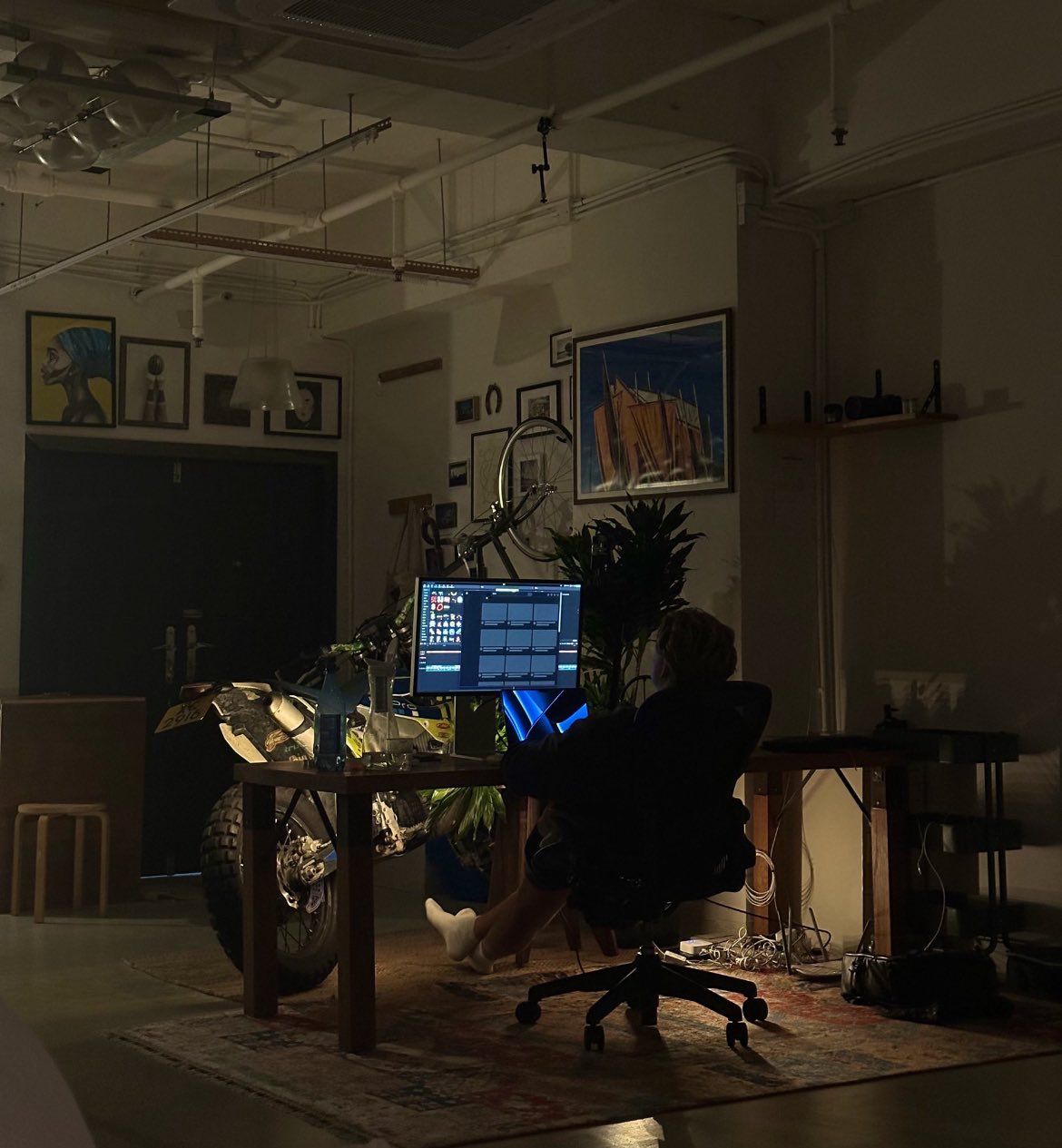 Aerial view of a winding road cutting through rocky terrain and sandy landscape.