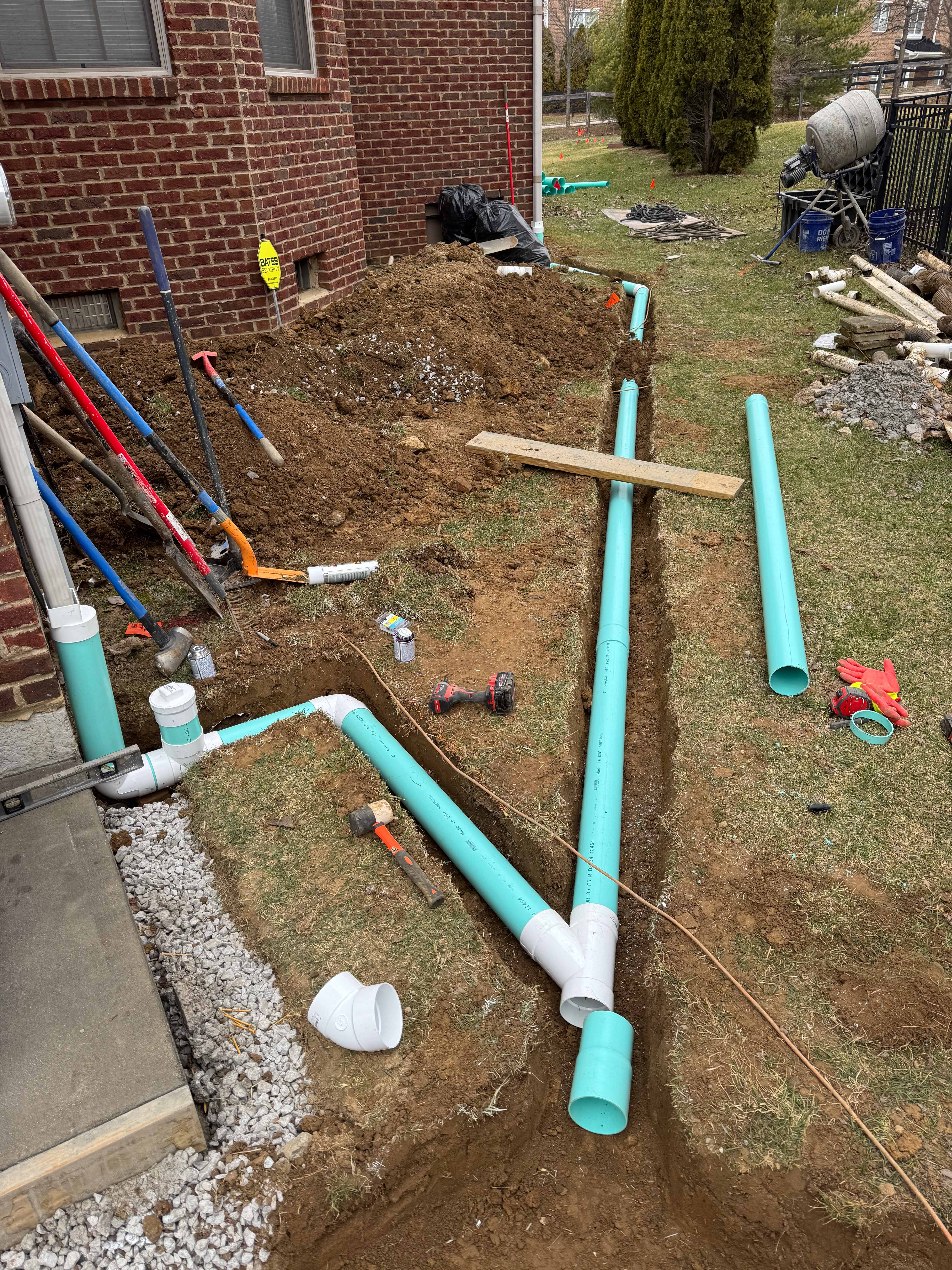 Green PVC drainage pipe system during trench installation