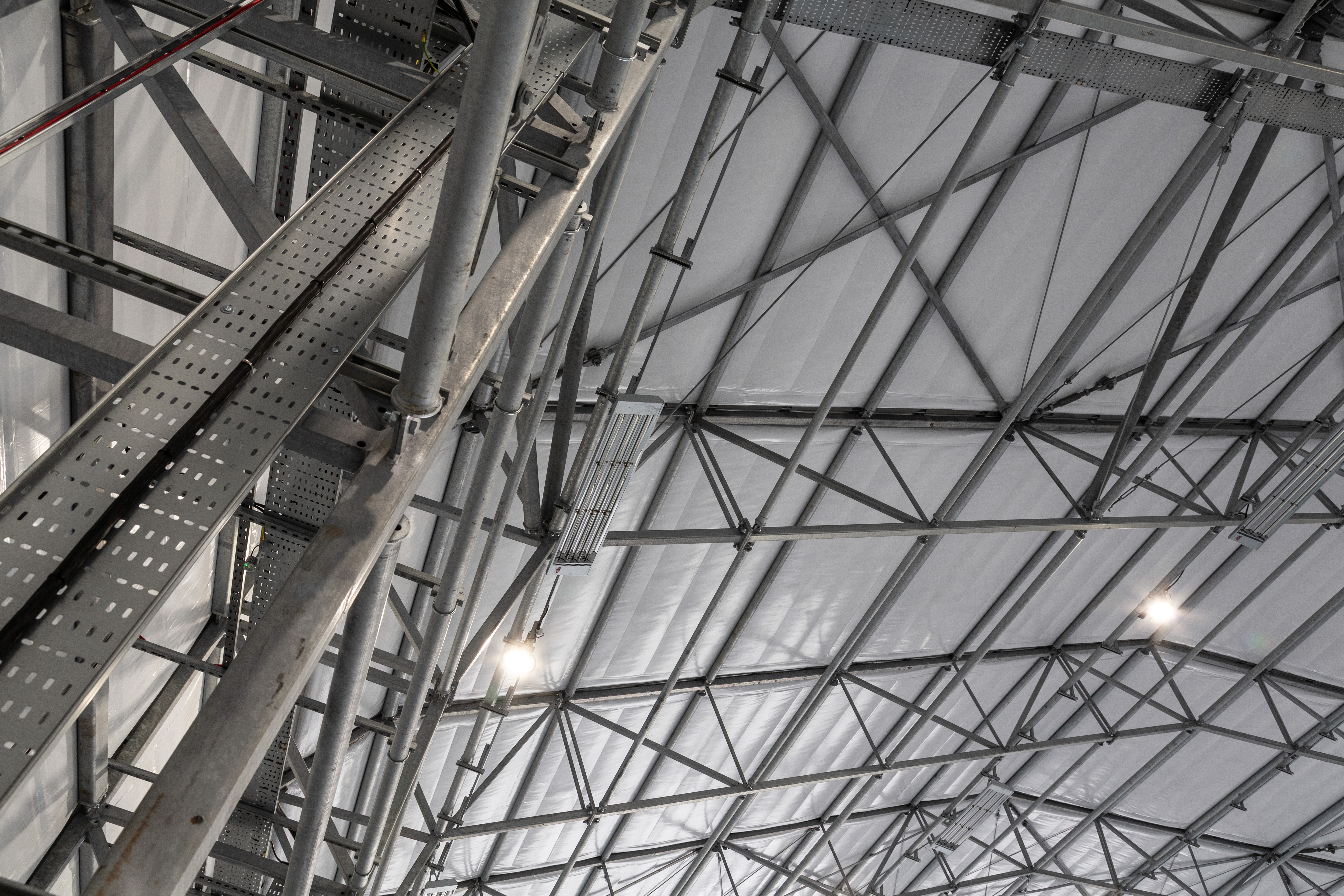 Modern concrete ceiling with industrial lighting fixtures.