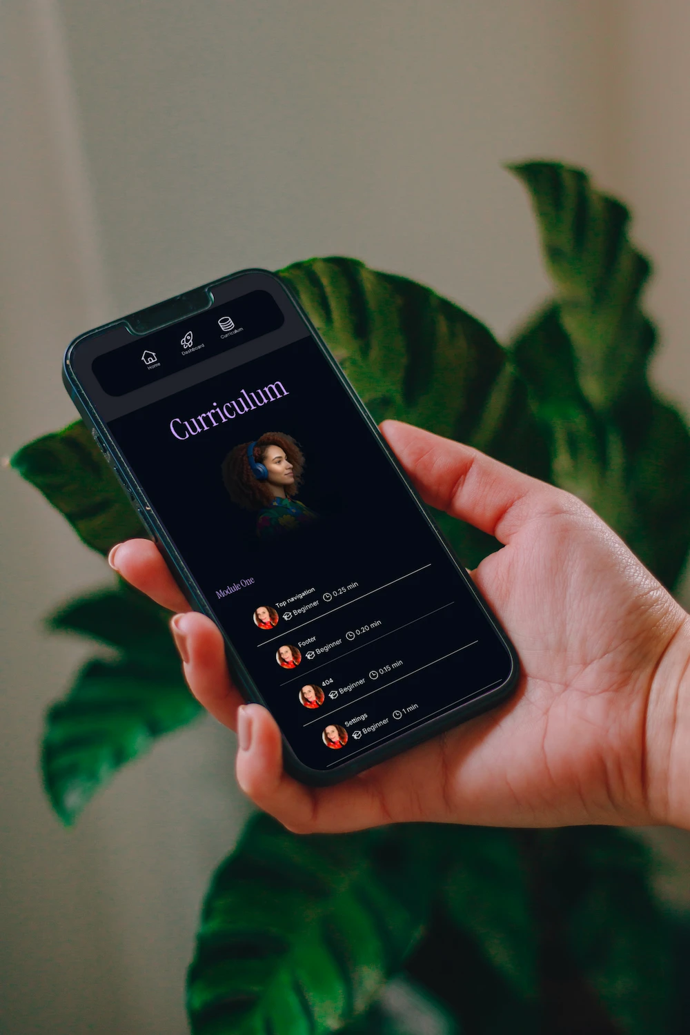 A hand held mobile shows the Learnoverse curriculum 