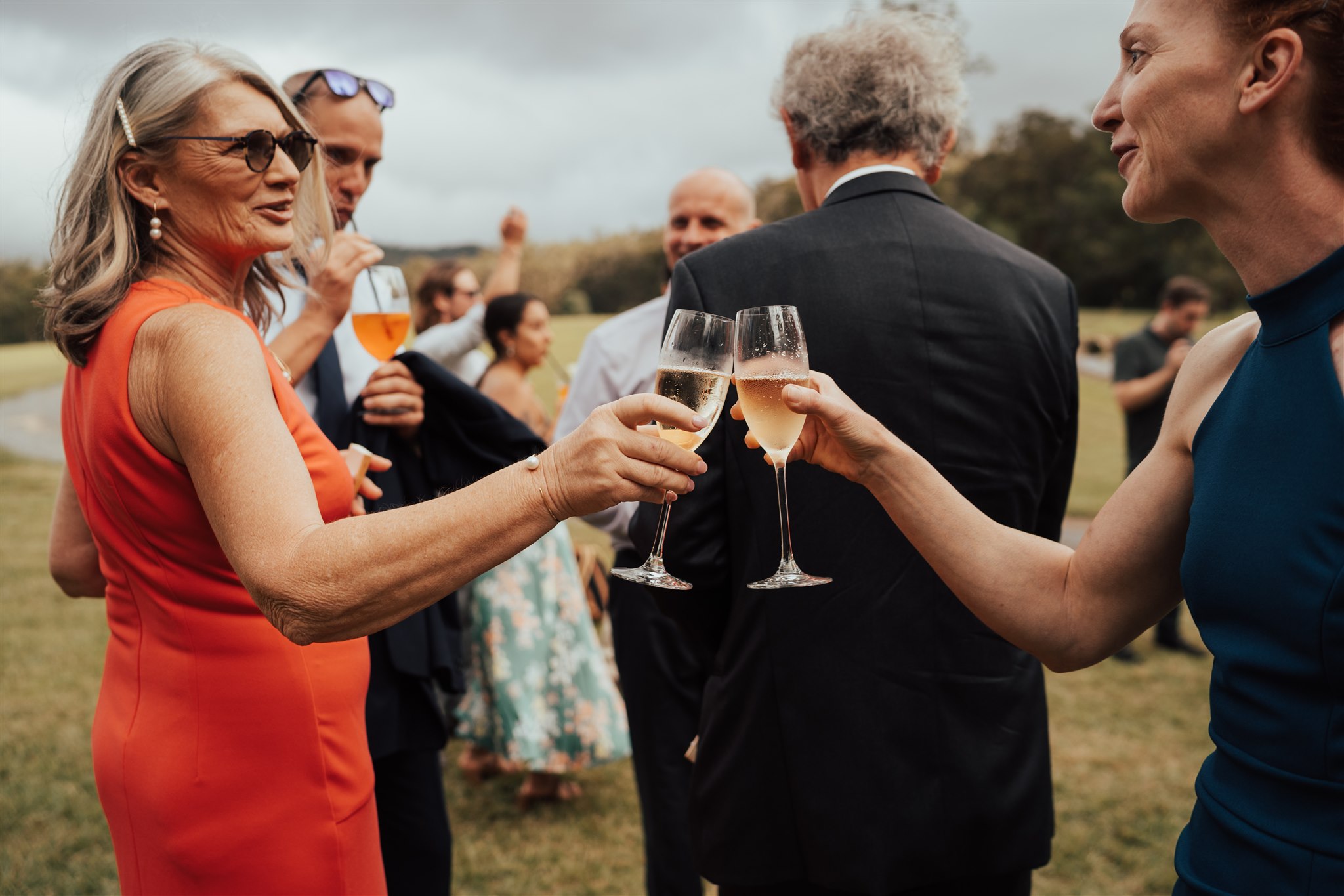 Guests cheering their champagne at a wedding at Gold Coast Farm House