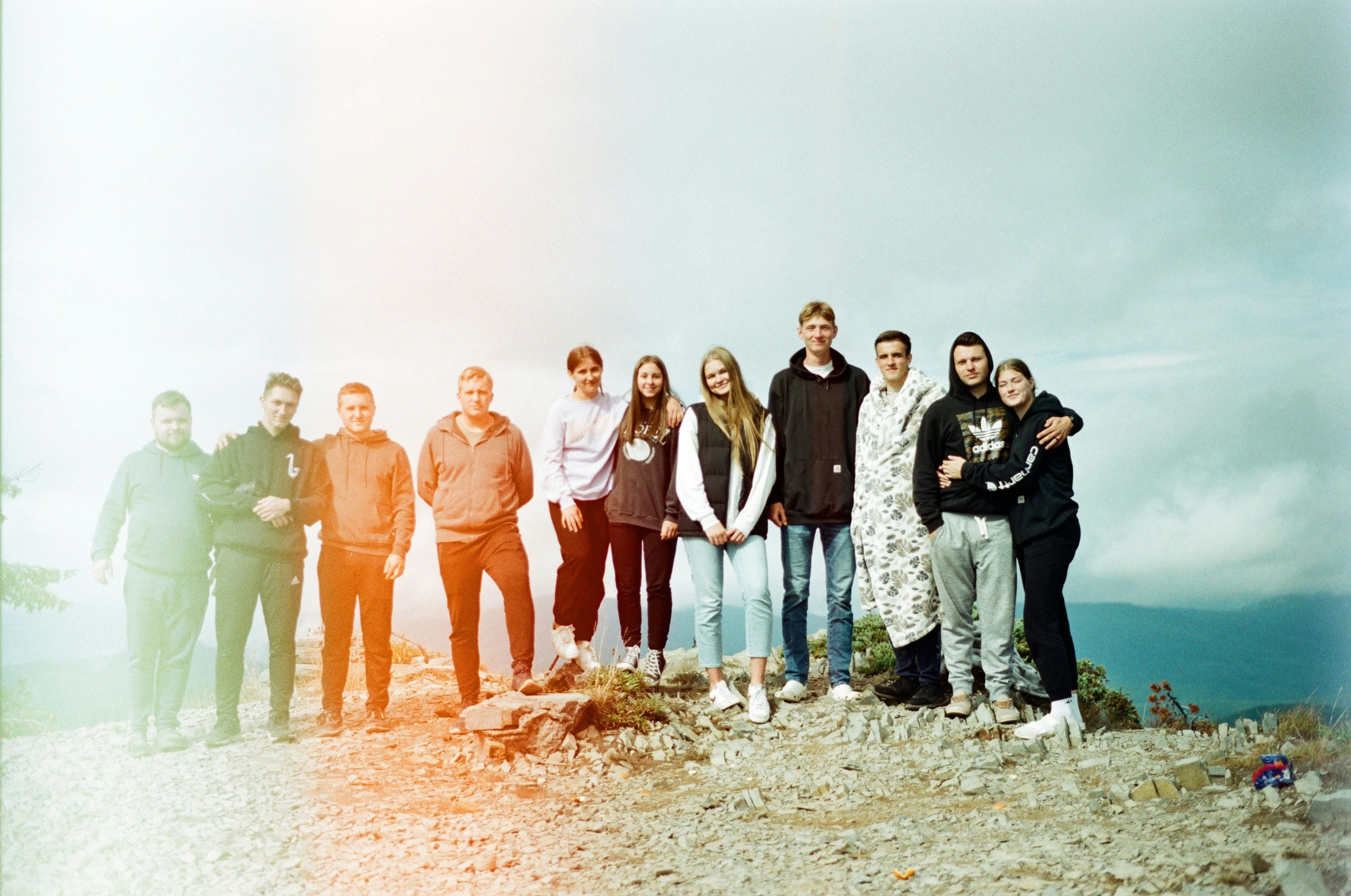 a group of people standing on top of a mountain