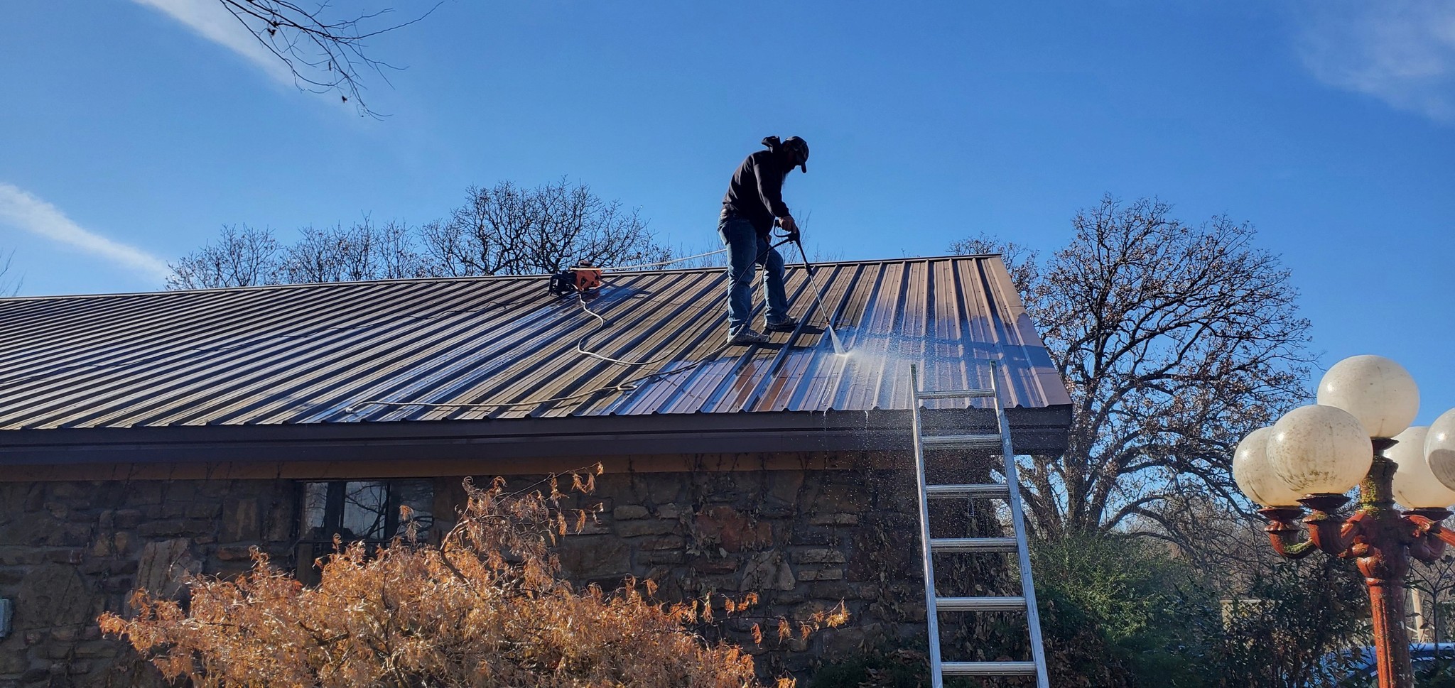 Image of Roofer Pressuring Washing a Roof Clean