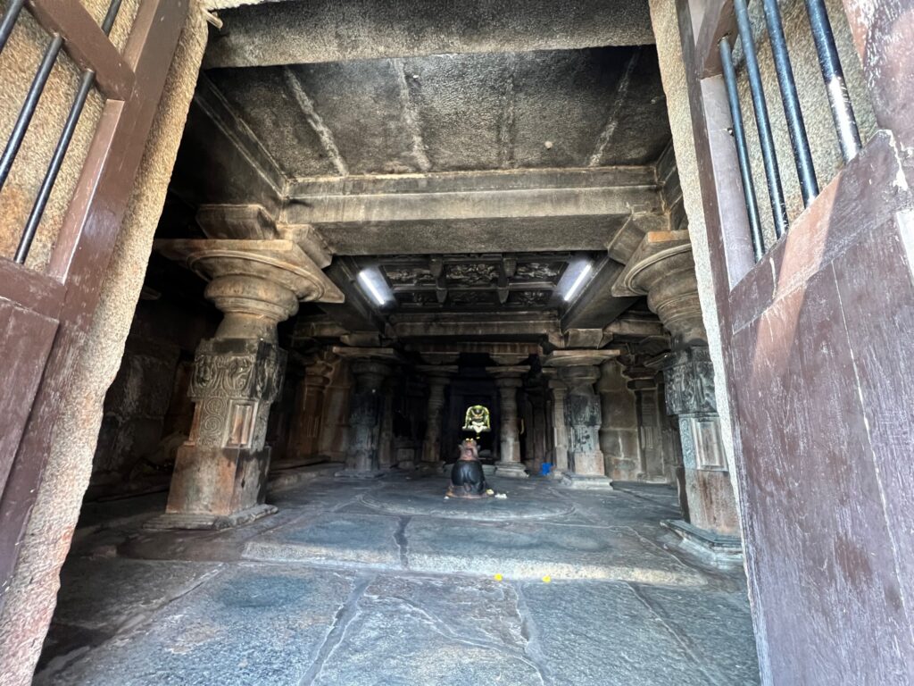 The Lakshmanalingeshwara temple with a Nandi facing it. The pillars and ceilings of the temple are carved beautifully. 