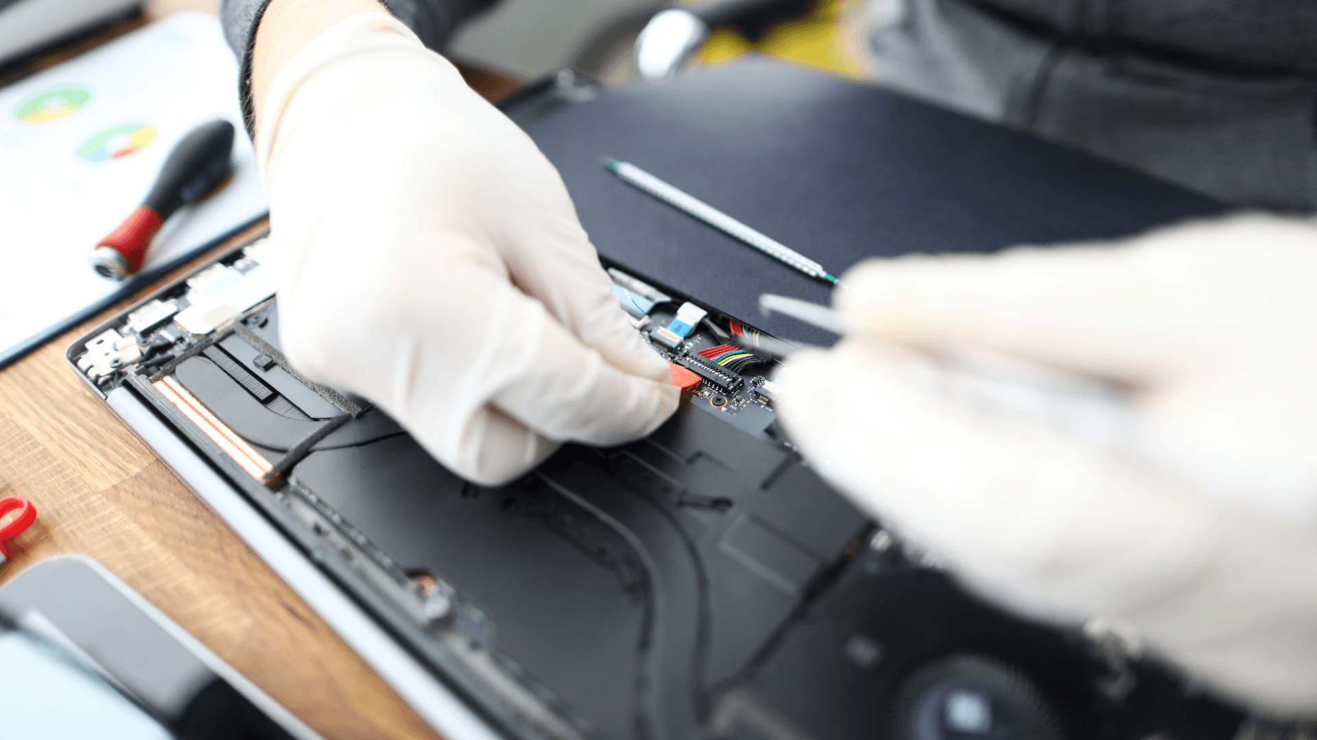 woman sitting around table holding tablet