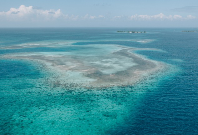 Aerial view over the the flats outside Placencia, Belize. Showing both deep blue water and shallow pancake flats