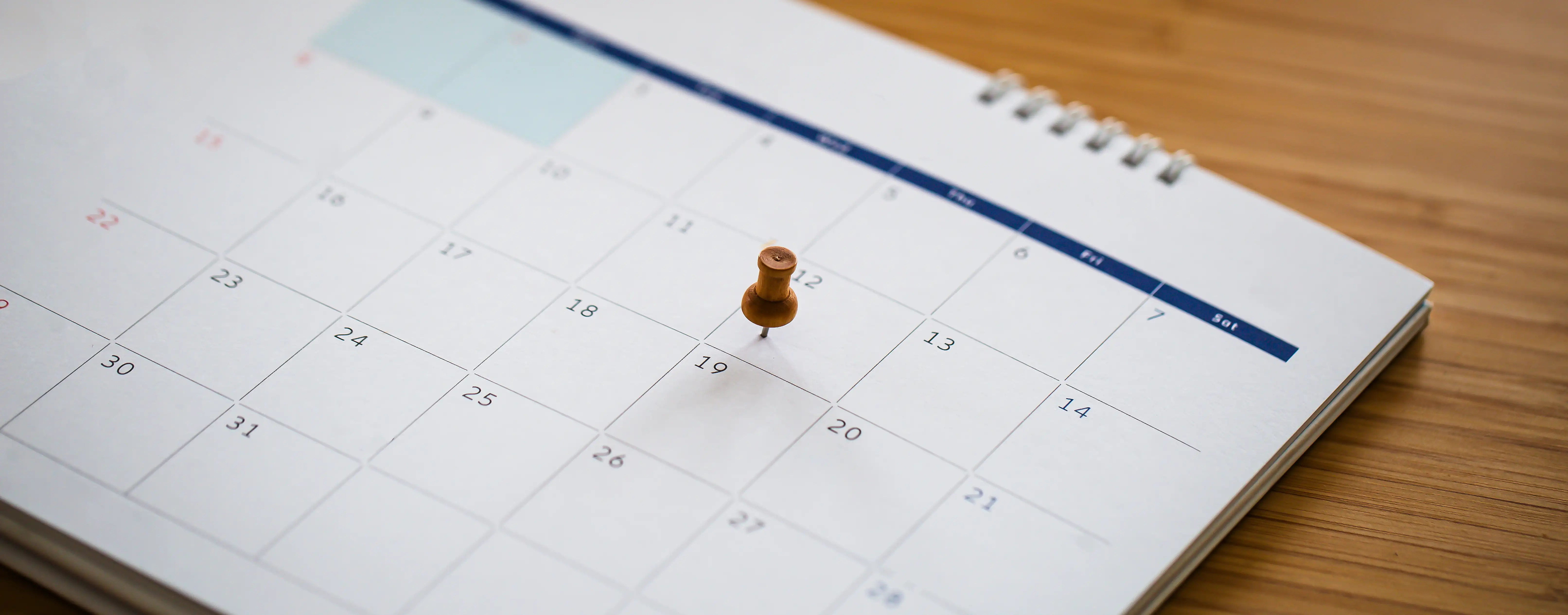 Desk calendar with a push pin marking a filing deadline date, illustrating the statute of limitations for California whistleblower retaliation claims under Labor Code Section 1102.5