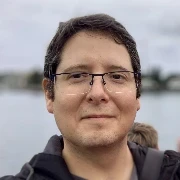 Smiling man with glasses and short brown hair