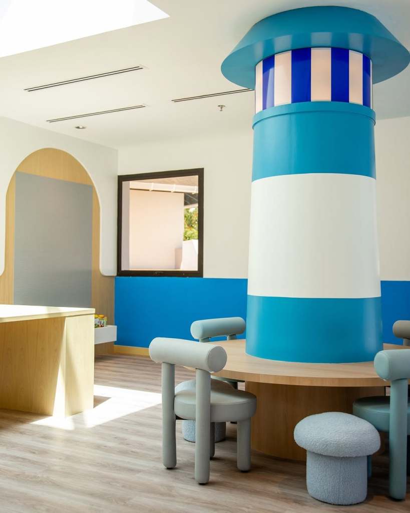 Interior view of the Hilton Kids Club at Hilton Kuching, featuring a colorful design with a blue lighthouse column and playful furniture.