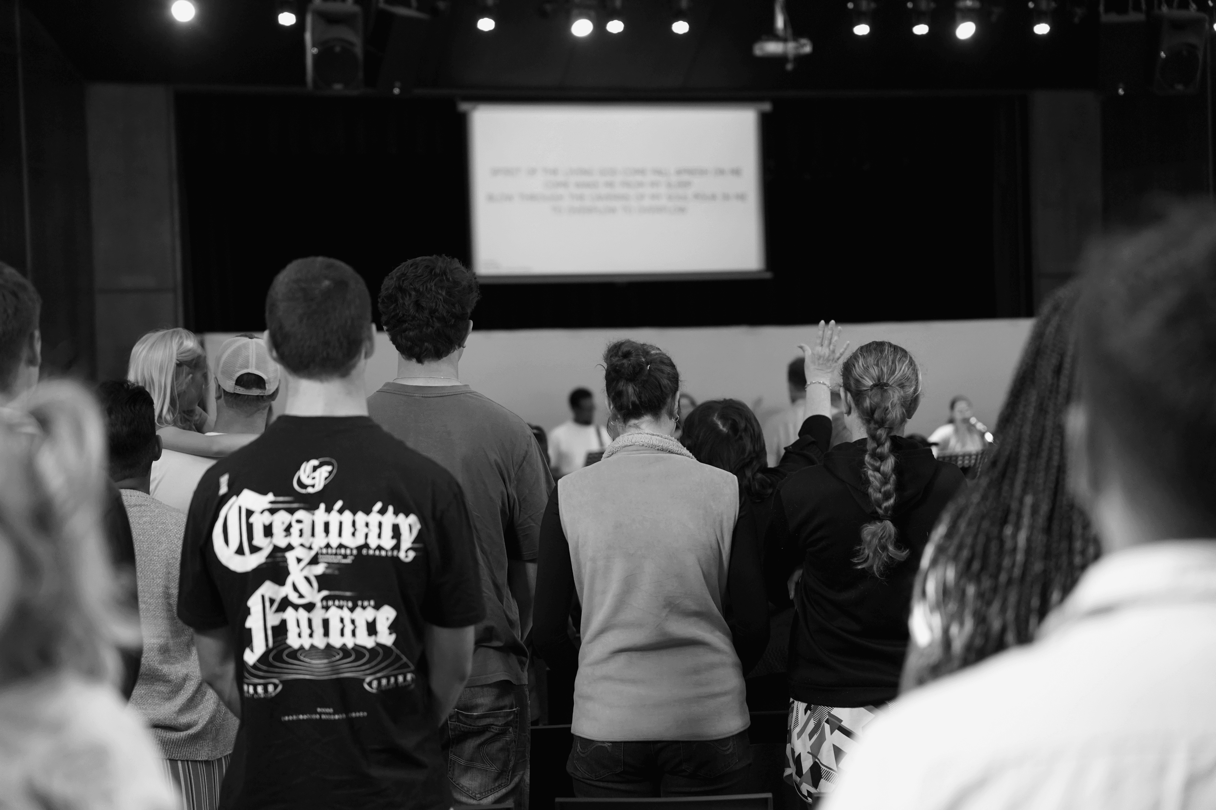 A person stands in a sandstone cave.