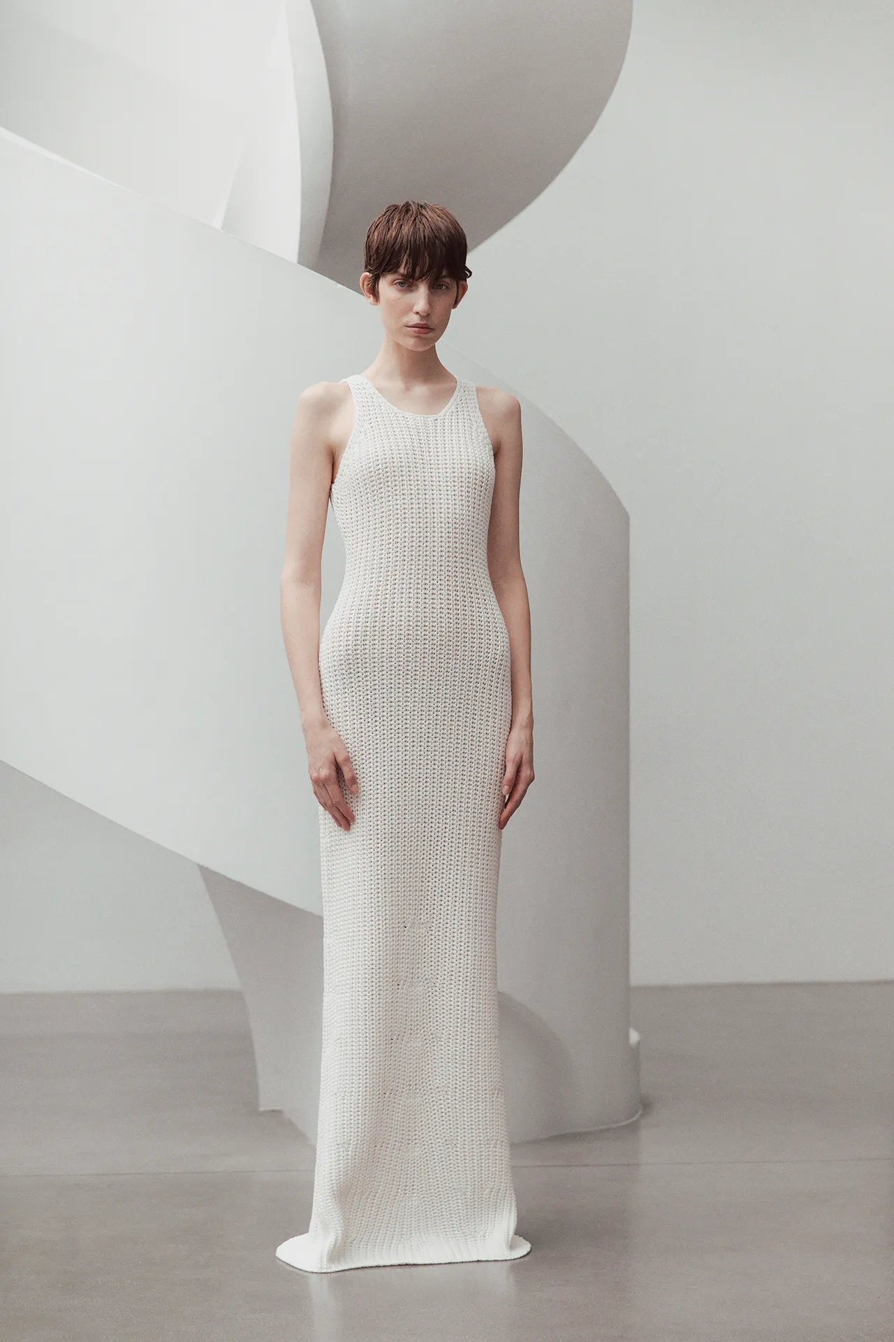 Aida Barni SS26 collection women's white sleeveless maxi dress featuring a textured open-stitch knit design.