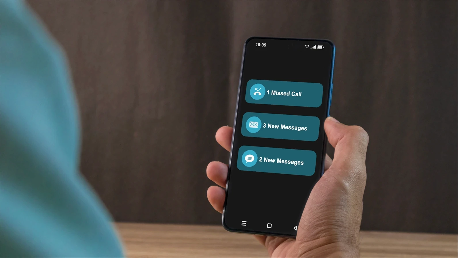 Man holding a smartphone with missed call and new message notification on the phone screen