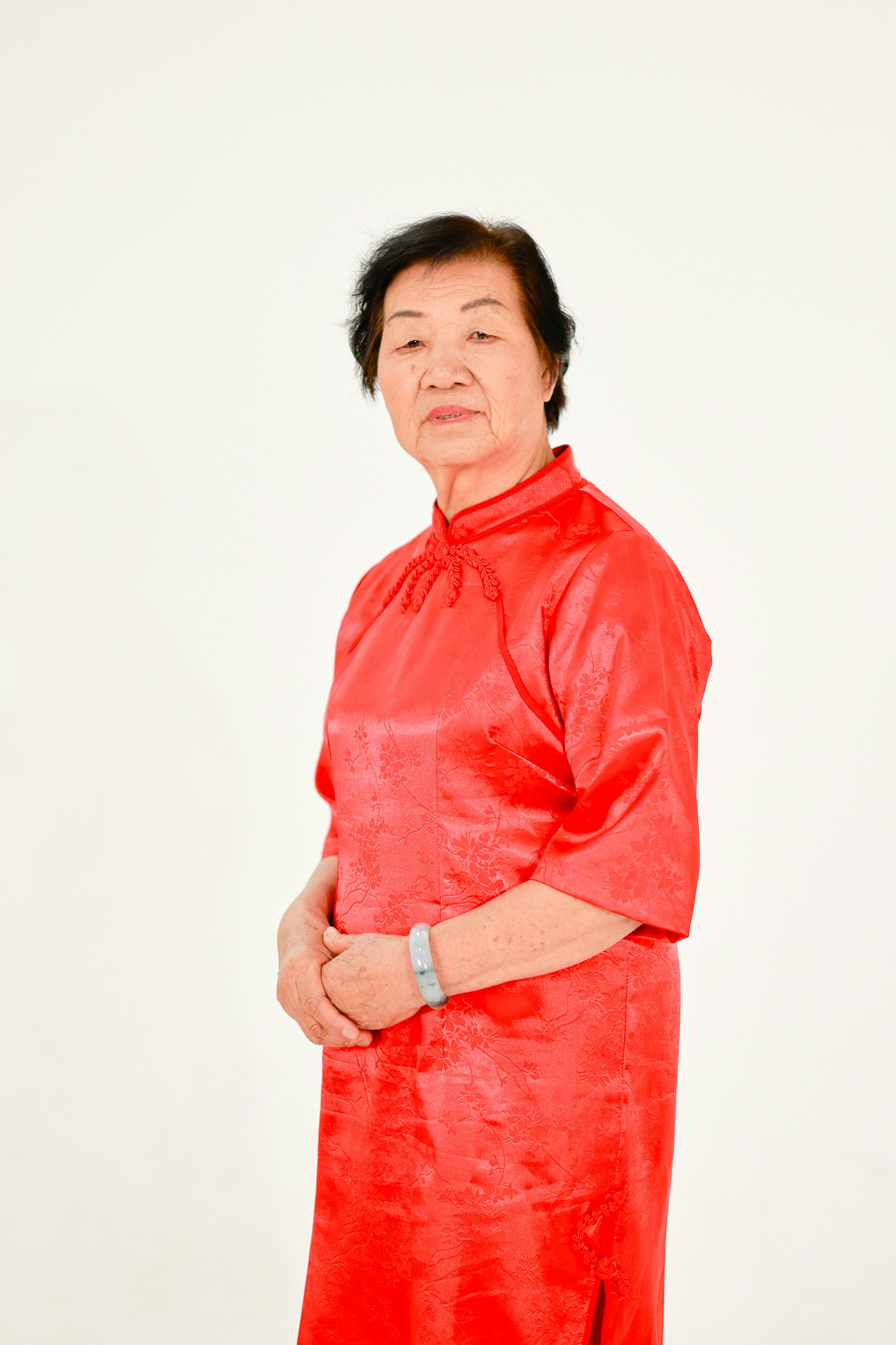 Elderly asian woman in a red dress
