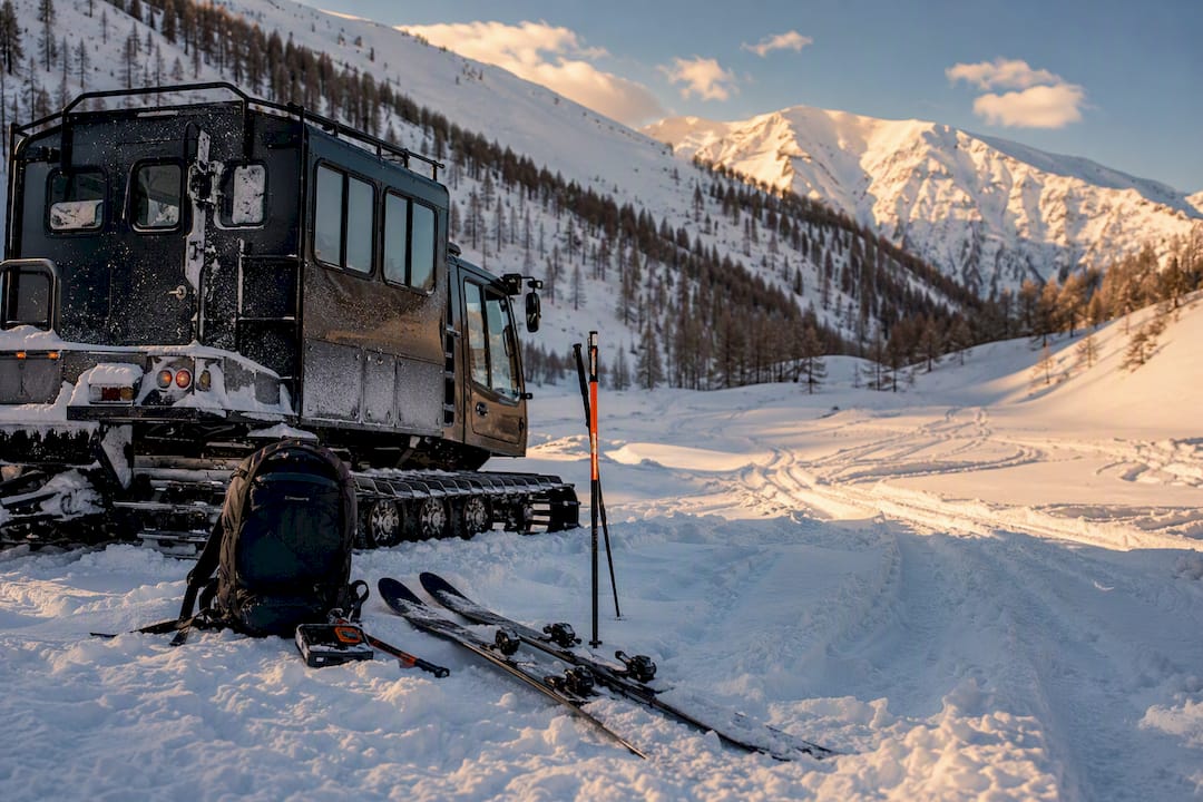Snowcat and avalanche equipment in a snowy mountain bowl