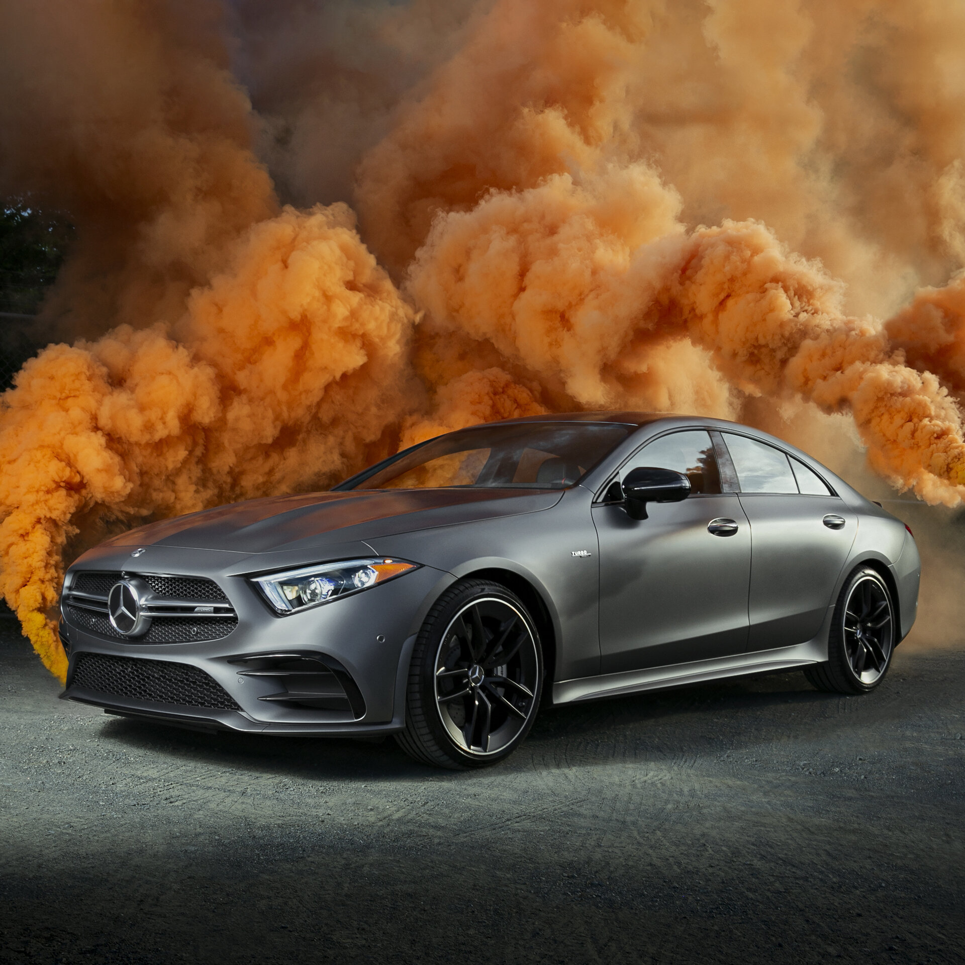 Mercedes-Benz AMG CLS parked with dramatic orange smoke in the background, photographed at Garage Isla Verde, Carolina, Puerto Rico.