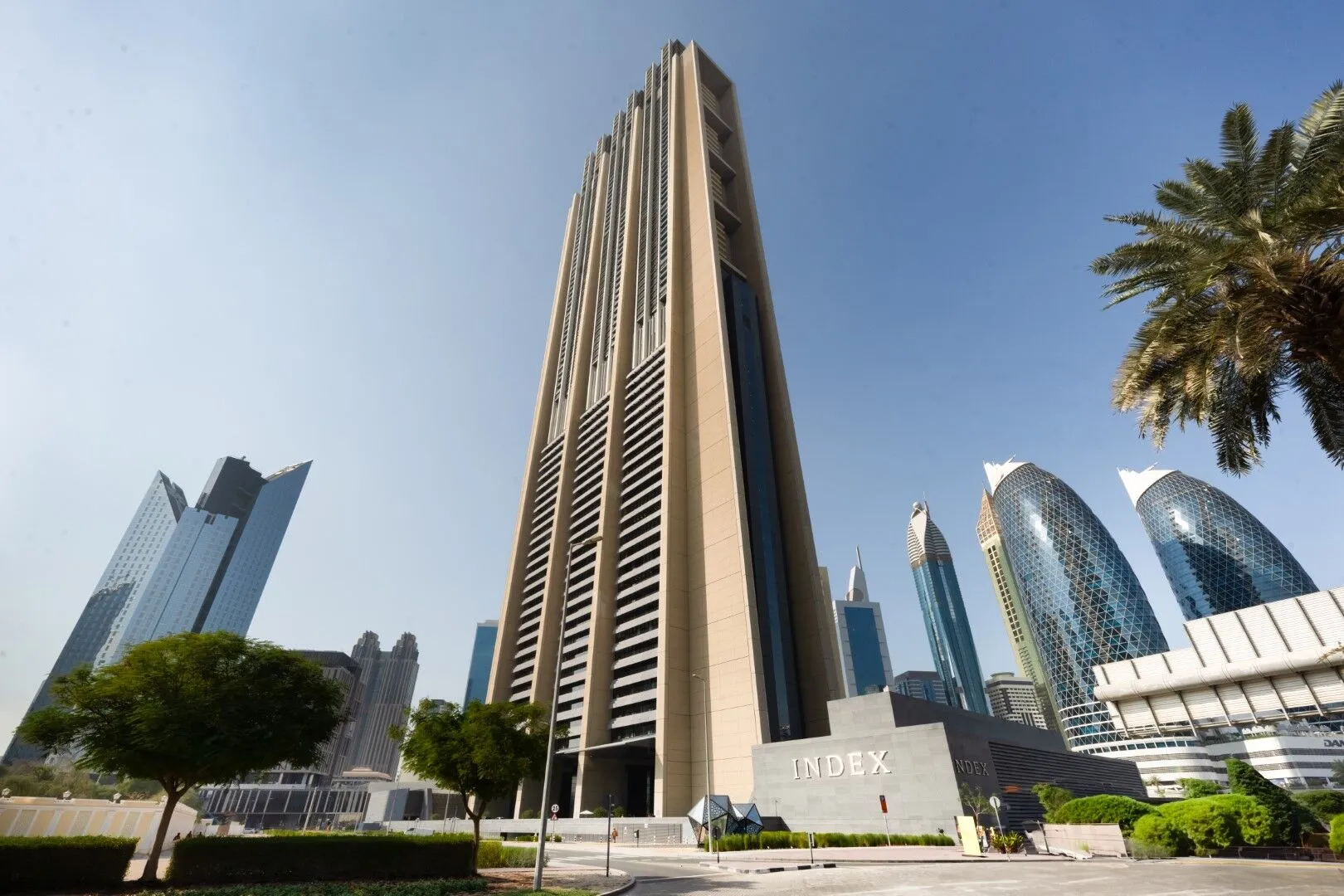 Close-up of the Index Tower entrance signage, representing elite real estate services in the business hub.
