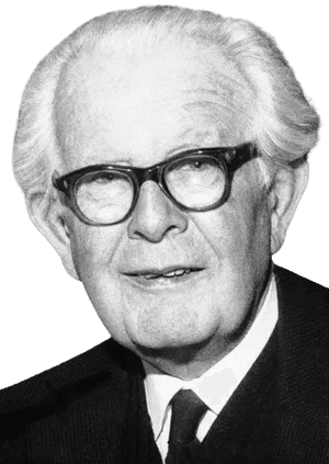 A black-and-white portrait of an elderly man with thick glasses and white hair, smiling gently. Dressed in a suit and tie, he exudes warmth and wisdom, suggesting he is a respected academic or intellectual. The background, with hints of books or documents, adds an intellectual and scholarly context to the image.