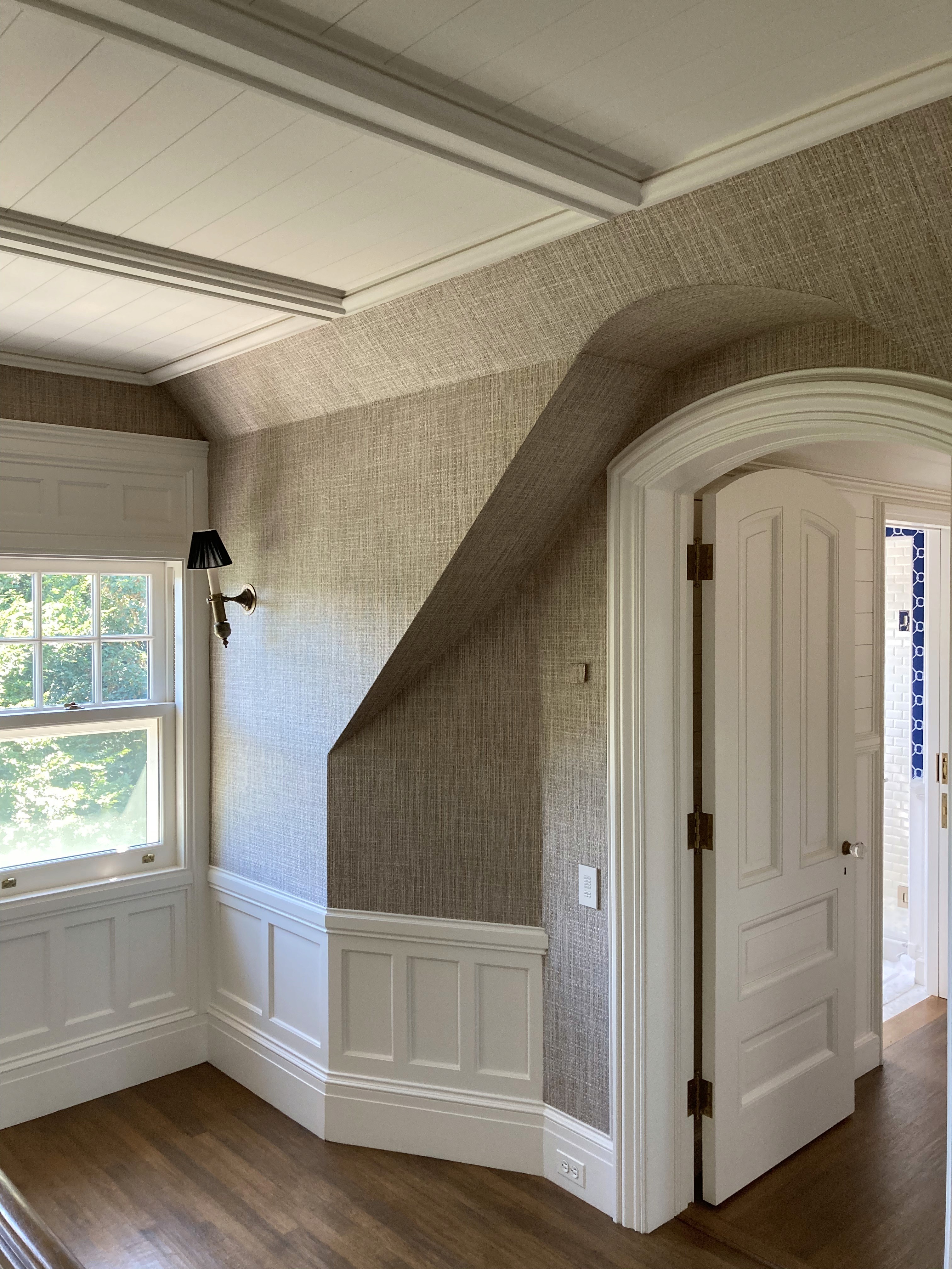 Taupe wallpaper and painted shiplap in hamptons home