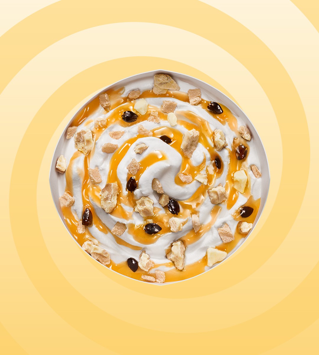A circular design featuring swirling patterns in shades of orange and white against a soft yellow background.