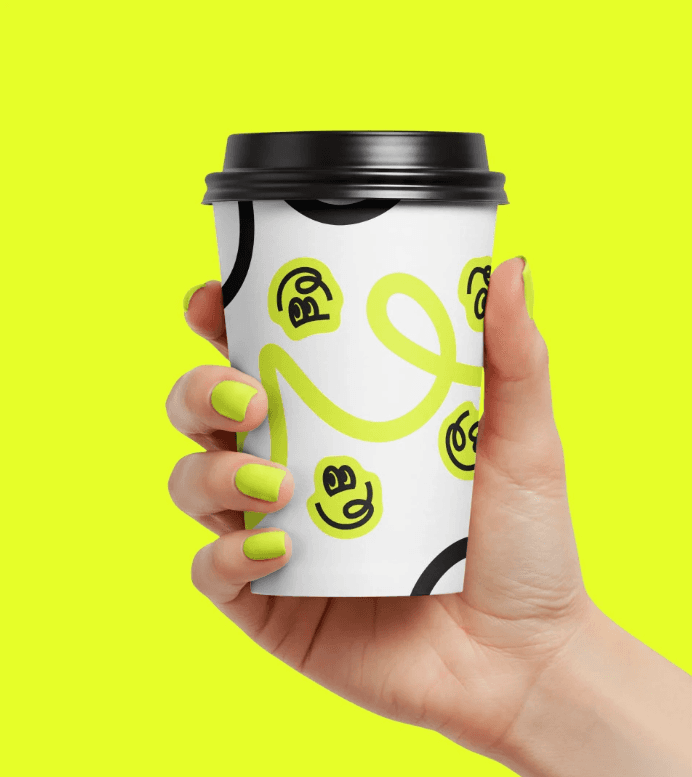 Hand holding product with branded smiley packaging