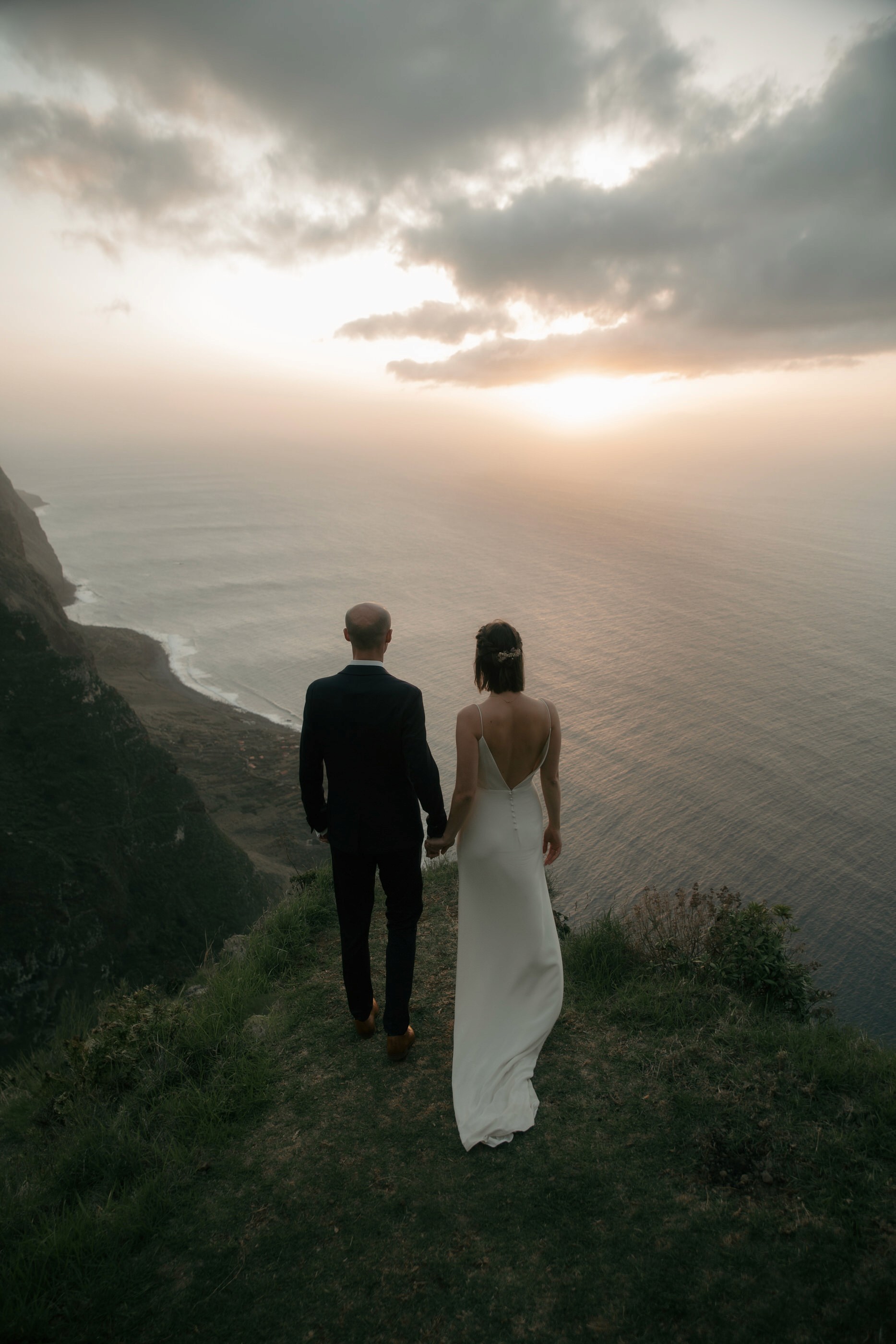 Elopement couple overlooking the Atlantic Ocean at sunset