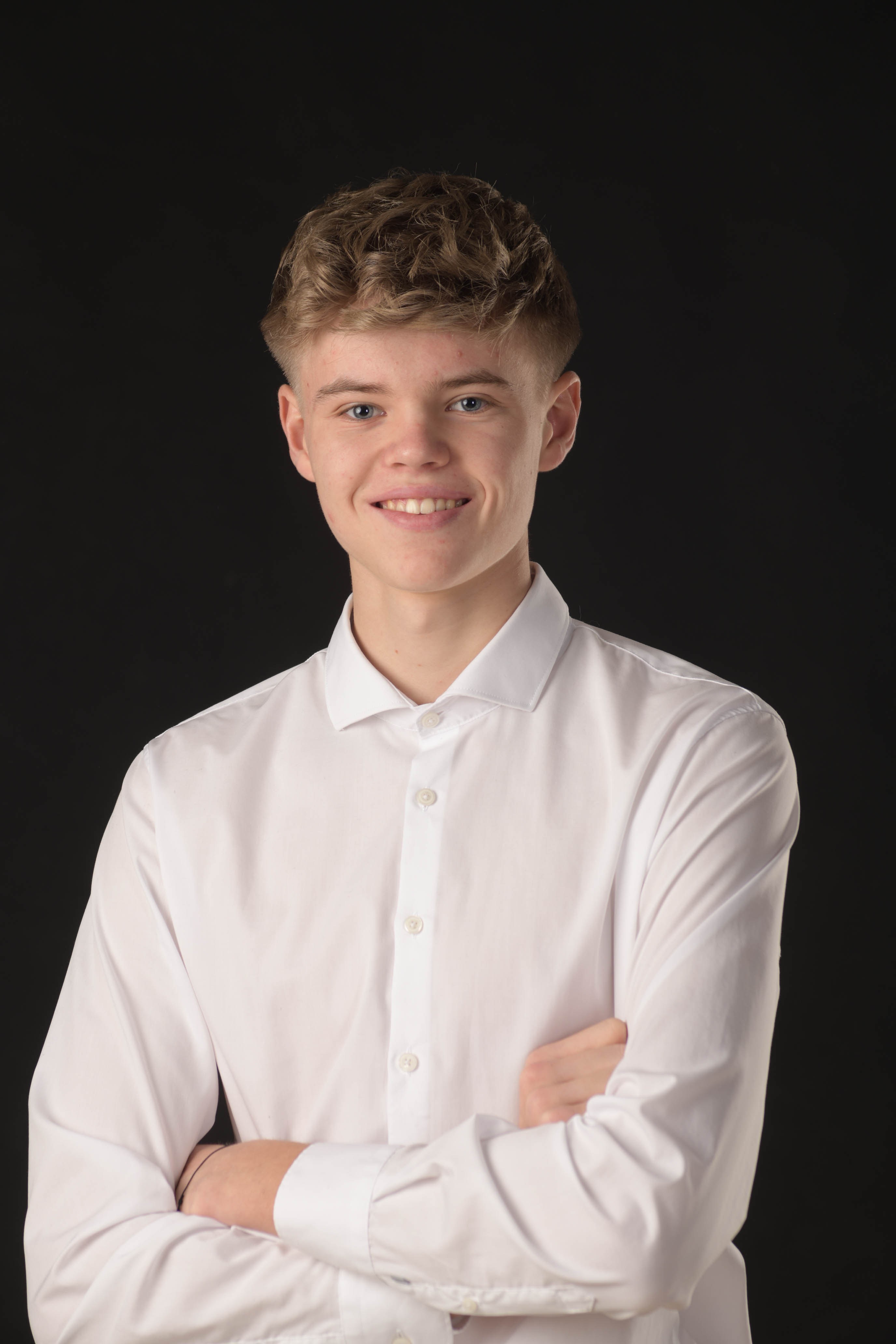 a man with a goatee smiles at the camera