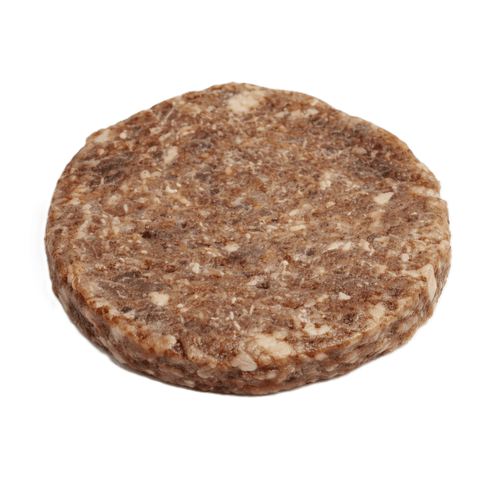 Man in apron stands in rustic kitchen, hands dusted with flour.